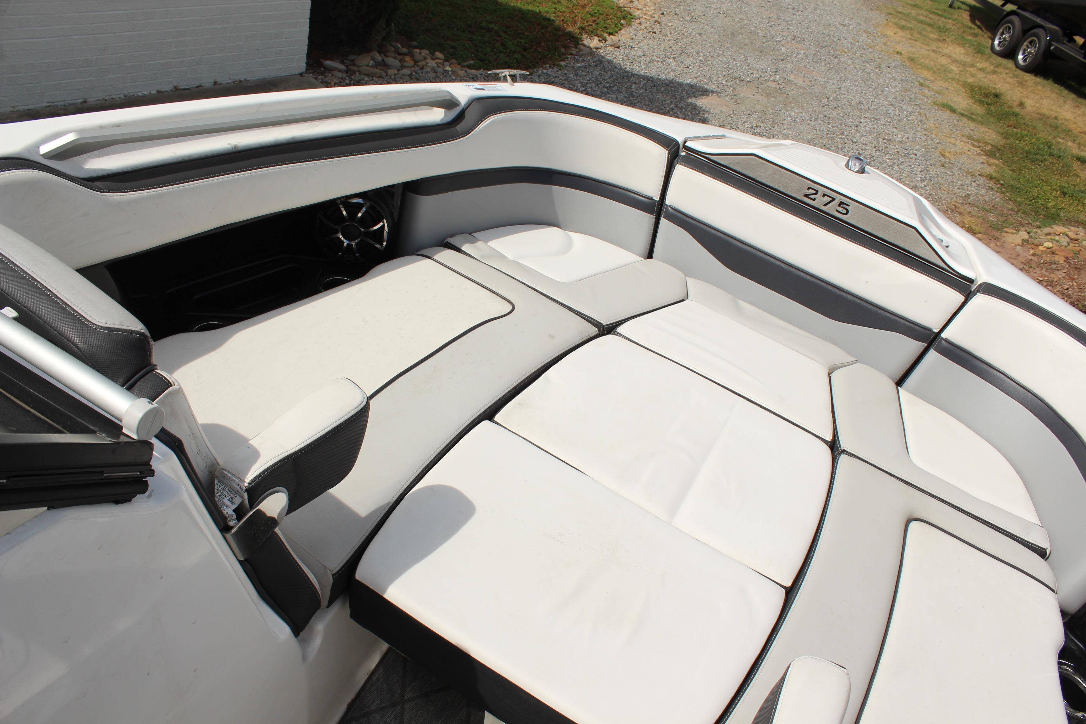2020 Yamaha Boats 275SE interior with white cushioned seating and sleek design.