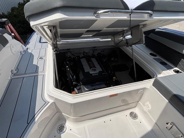 2026 Chaparral SSX 6 boat engine compartment with open hatch, showcasing interior details.