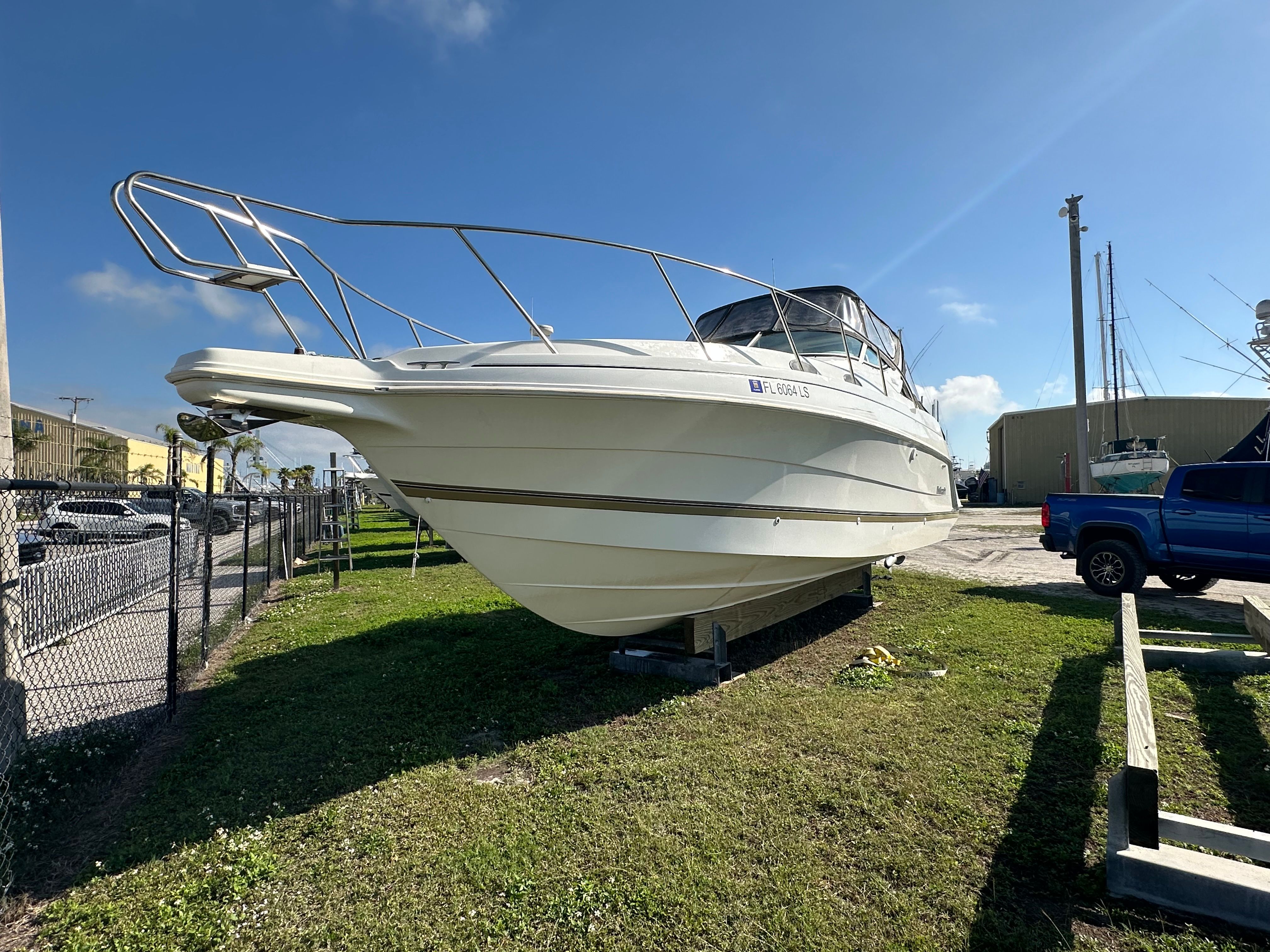 1999 Wellcraft 3000 Martinique boat on a parking lot.