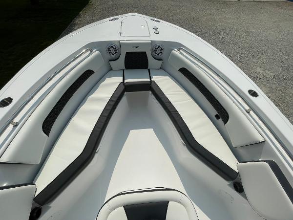 2025 Tidewater 232 CC Adventure boat interior with cushioned seating and speakers.