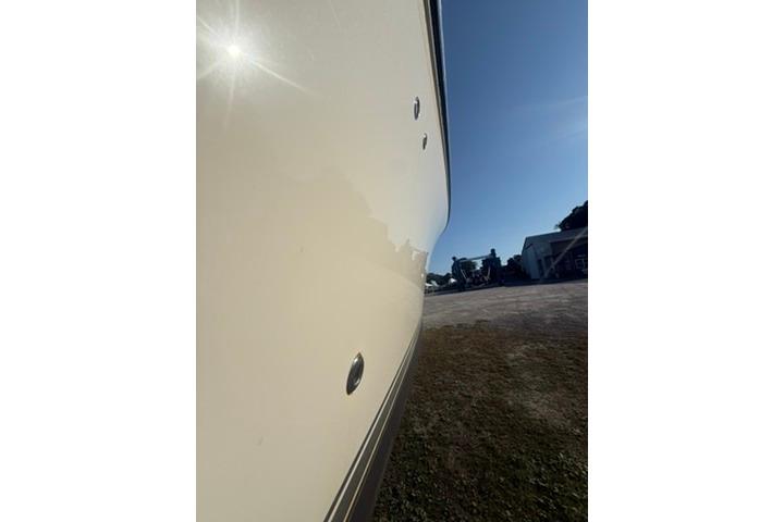 2010 Pursuit OS 375 Offshore boat hull under bright sunlight.