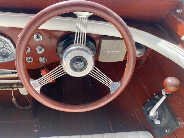Steering wheel and controls of a 2000 Grand Craft Classic Runabout boat.