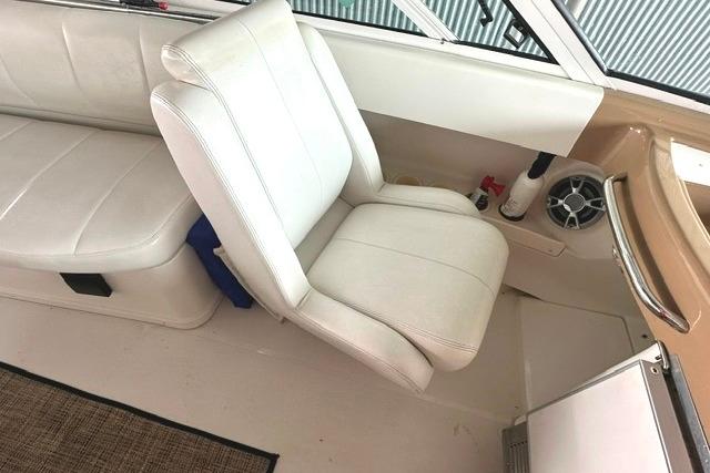 Interior of 2004 Carver 360 Mariner boat with white seating and speaker.