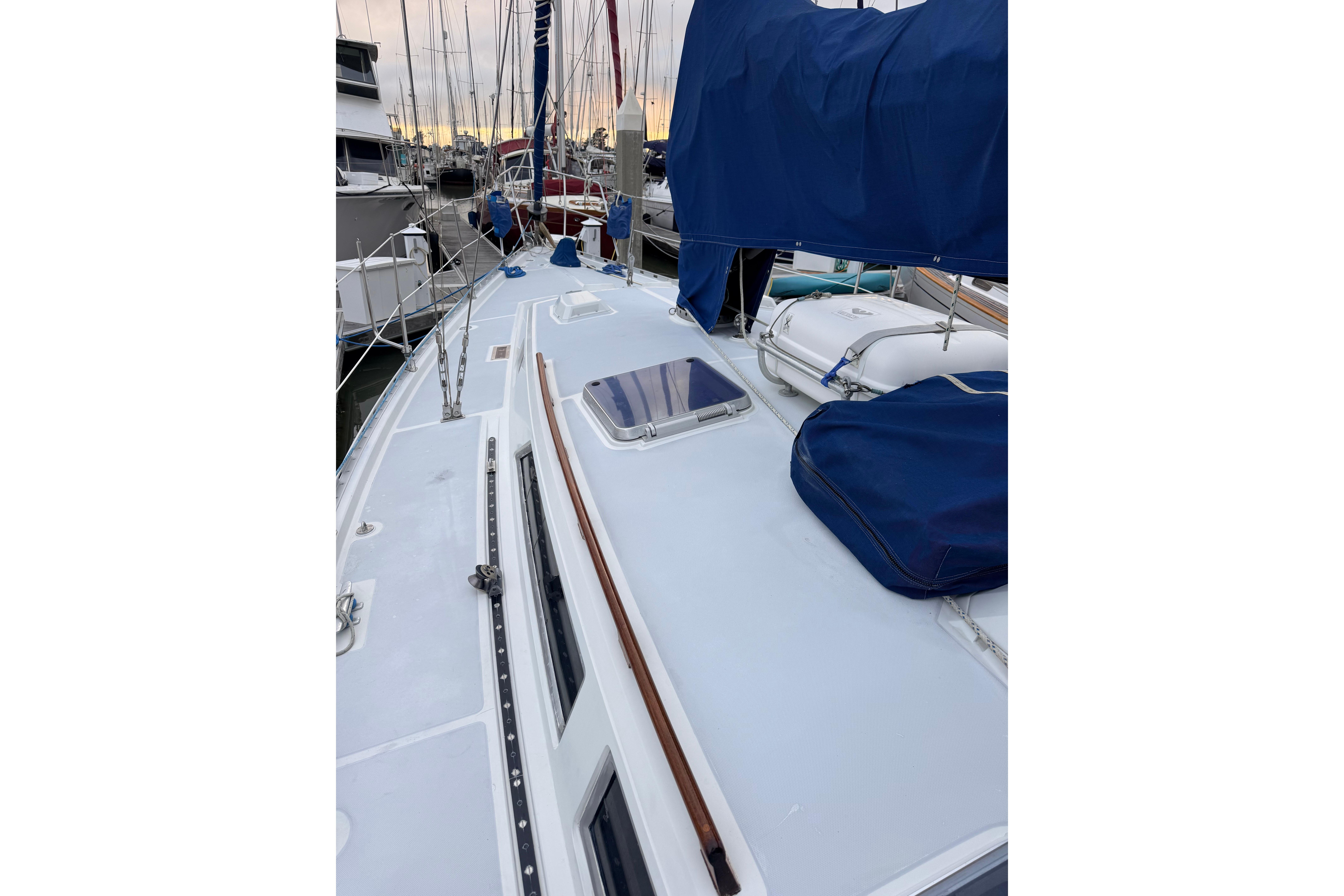 1987 Norseman 400 sailboat deck with blue covers, docked in a marina.