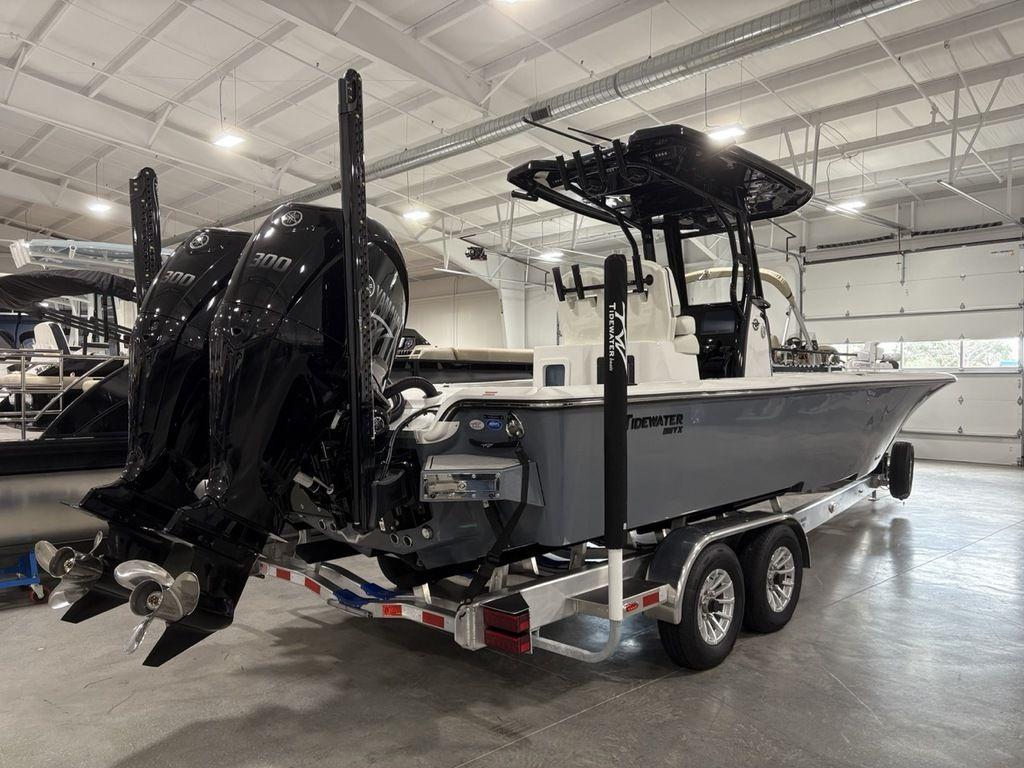 2026 Tidewater 2700 CB boat with dual engines on a trailer in a showroom.