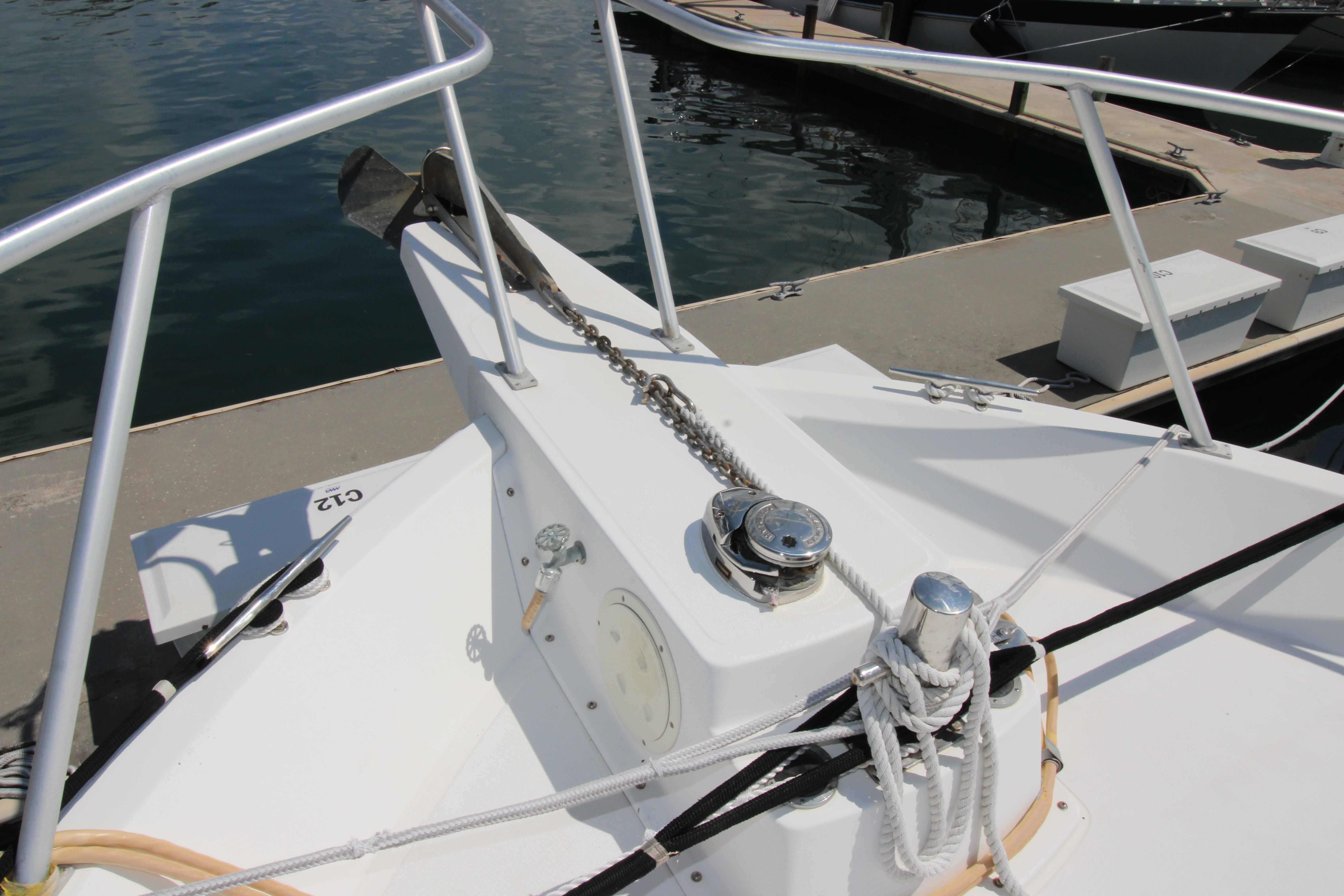 Bow of 2000 Ricker 42 Classic yacht with anchor chain and docked at marina.
