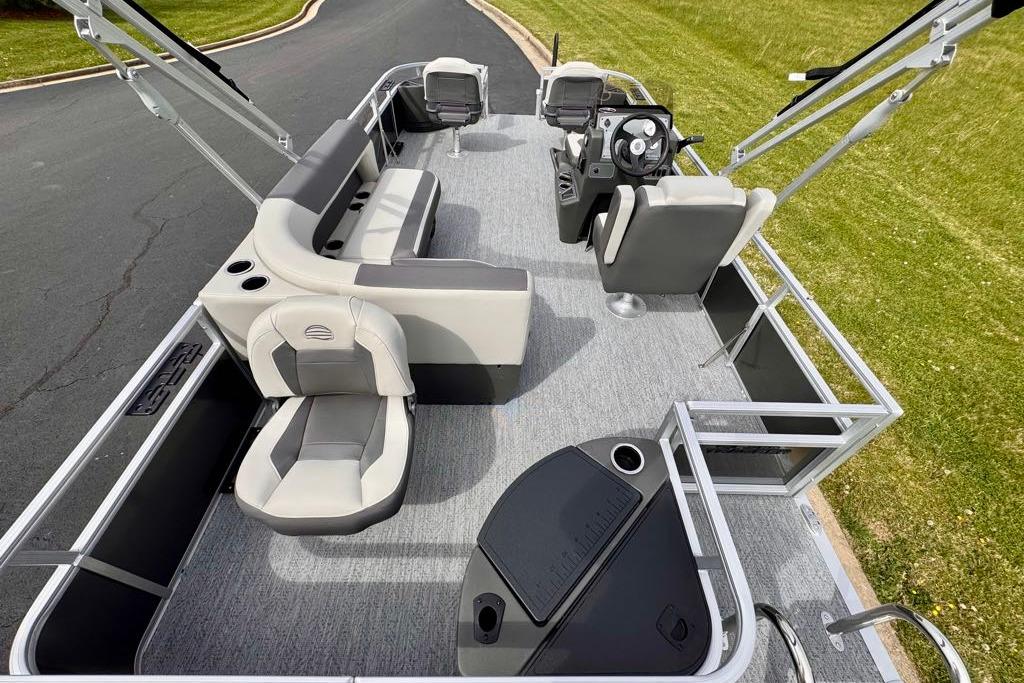 2026 Sun Tracker Bass Buggy 18 DLX pontoon boat interior with seating and steering console.