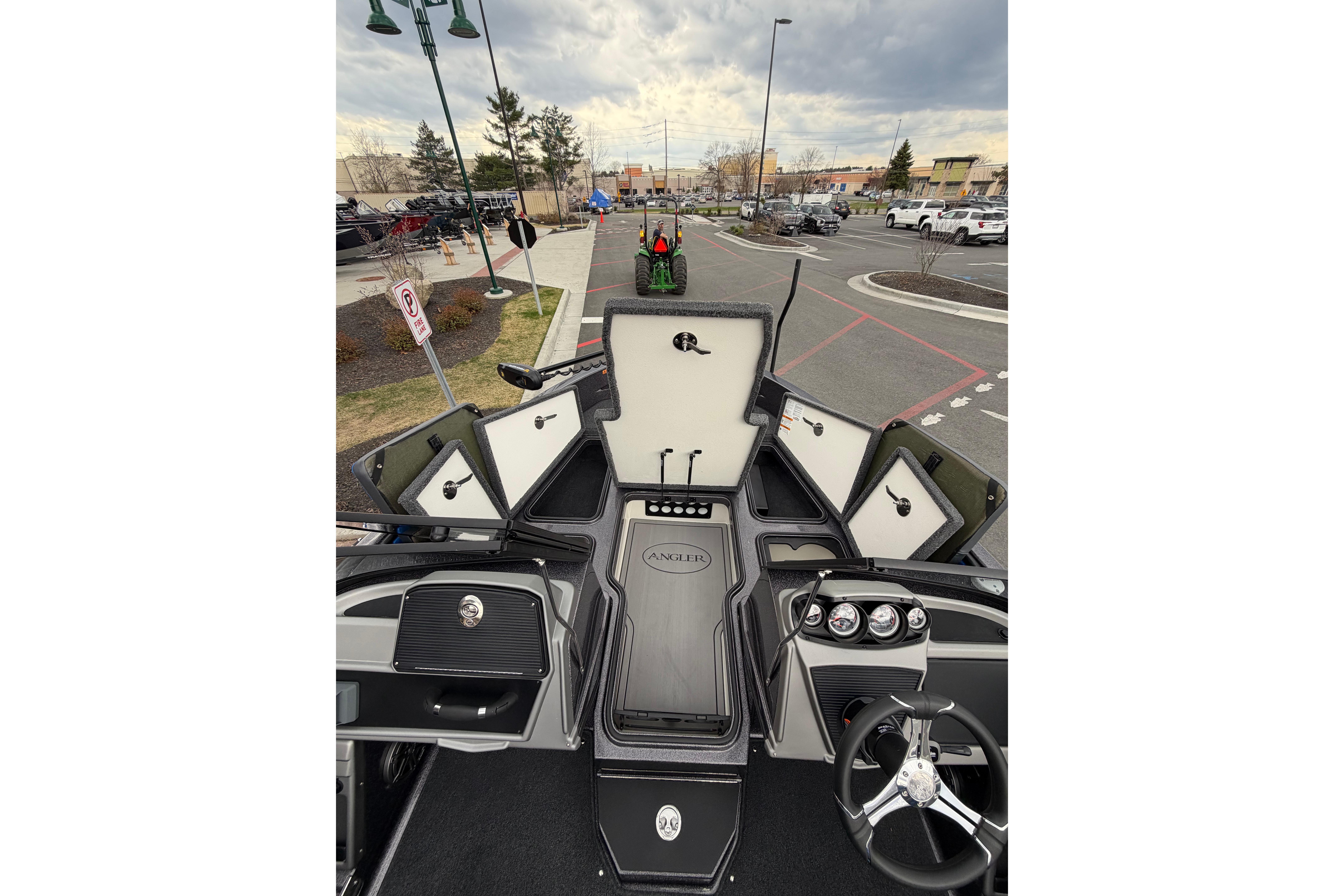 2026 Ranger 1880MS boat interior with open storage compartments and steering wheel.