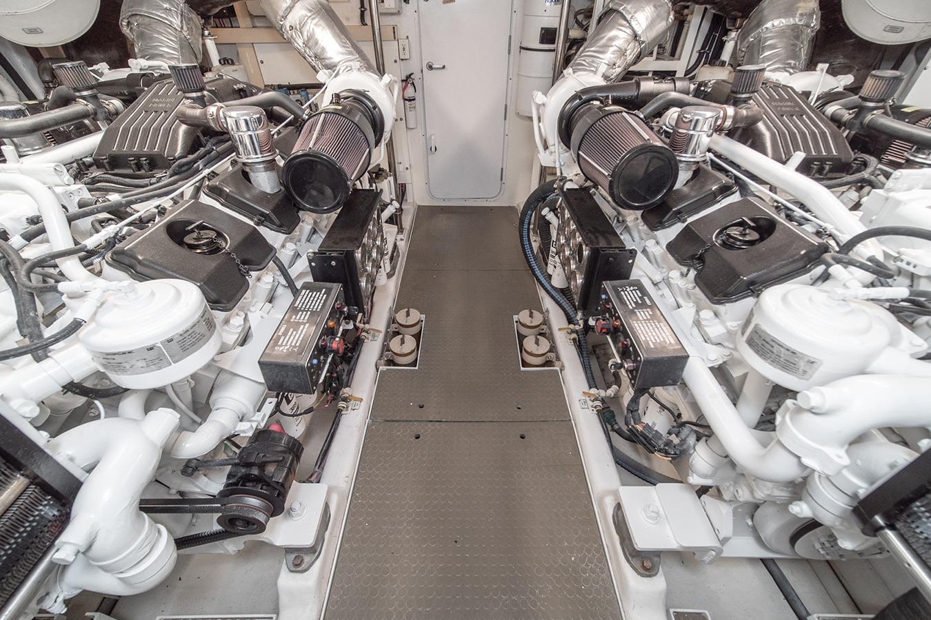 Engine room of 2003 West Bay Sonship yacht, featuring dual engines and mechanical components.
