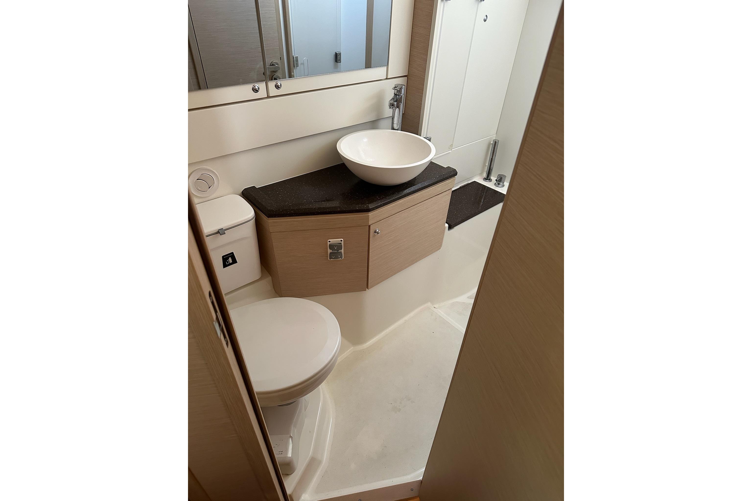 Bathroom interior of 2018 Jeanneau 51 yacht with modern fixtures and sleek design.