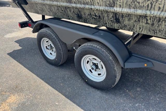 Trailer wheels of a 2026 Tracker Grizzly 2072 CC boat on pavement.