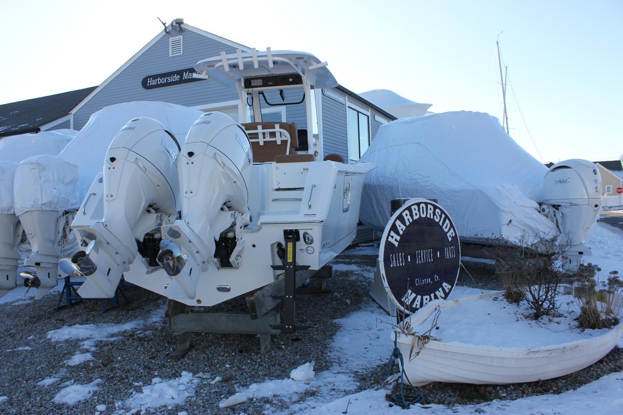 2026 Sea Hunt Gamefish 25 boat with twin engines at Harborside Marina in winter storage.