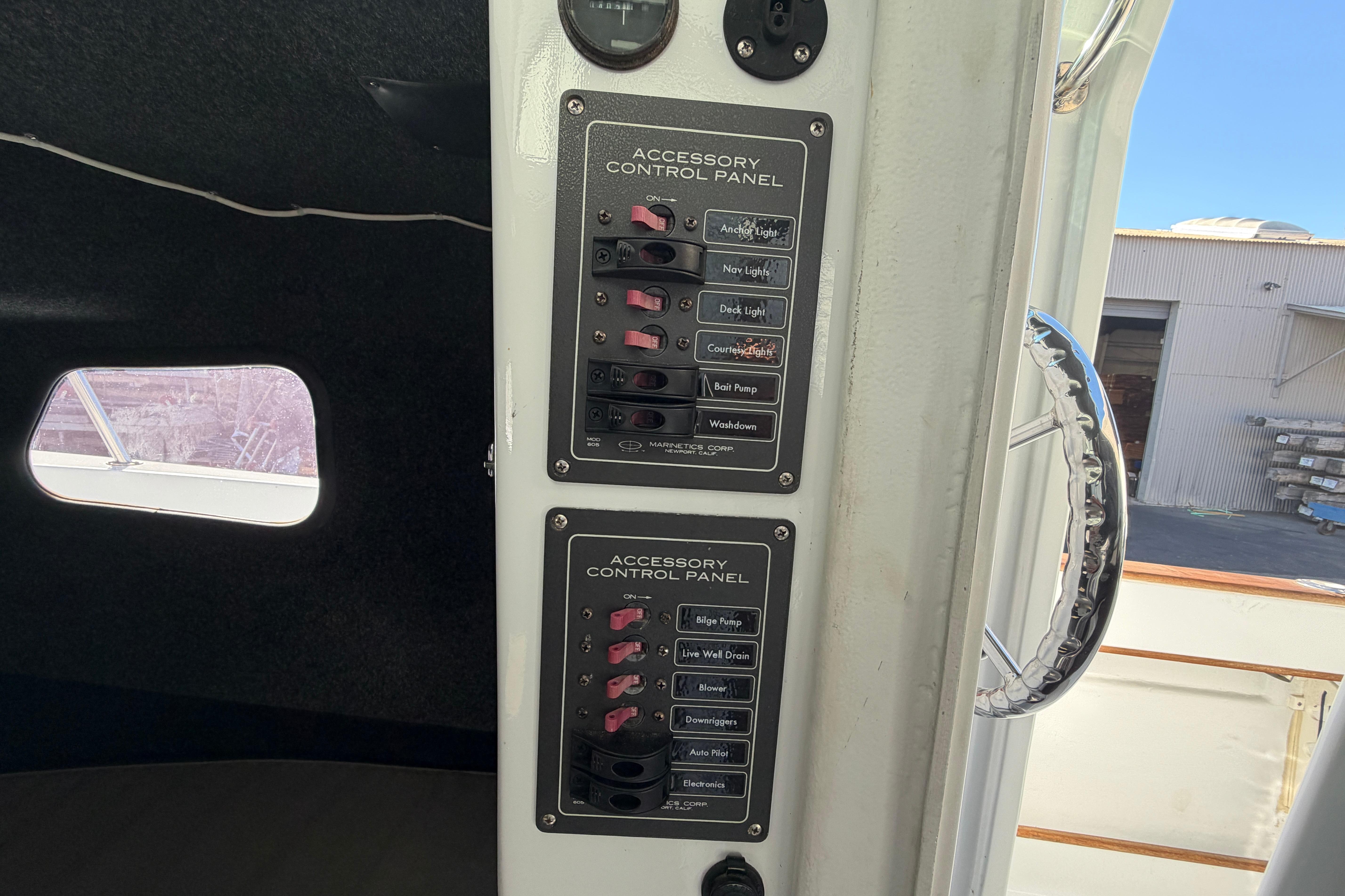 Accessory control panels inside a 1986 Radon 21 Sport boat, featuring various switches.