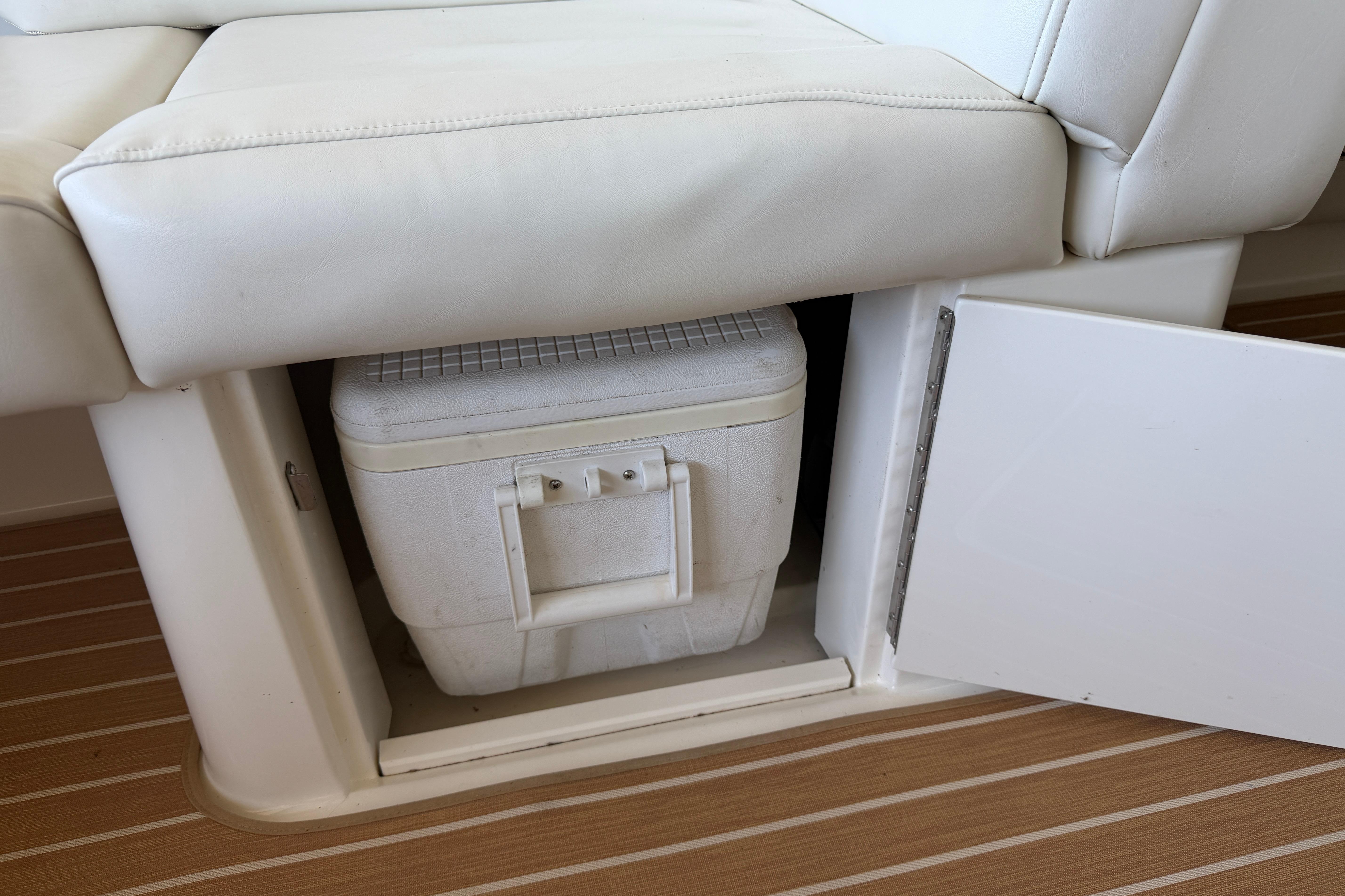 Storage compartment with cooler under seat on 2007 Sea Ray 270 SLX boat.