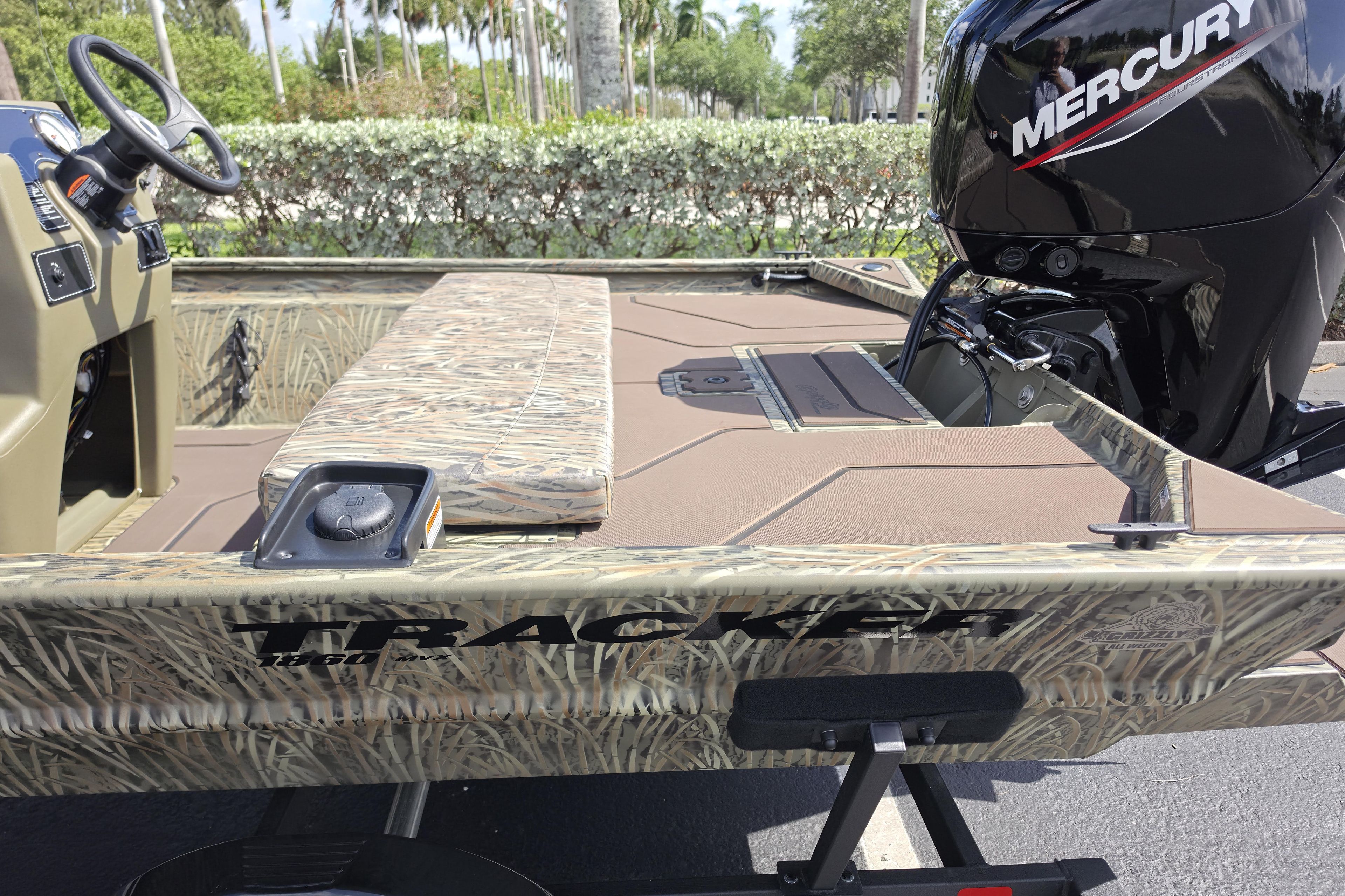 2026 Tracker Grizzly 1860 CC boat with camo design and Mercury engine.