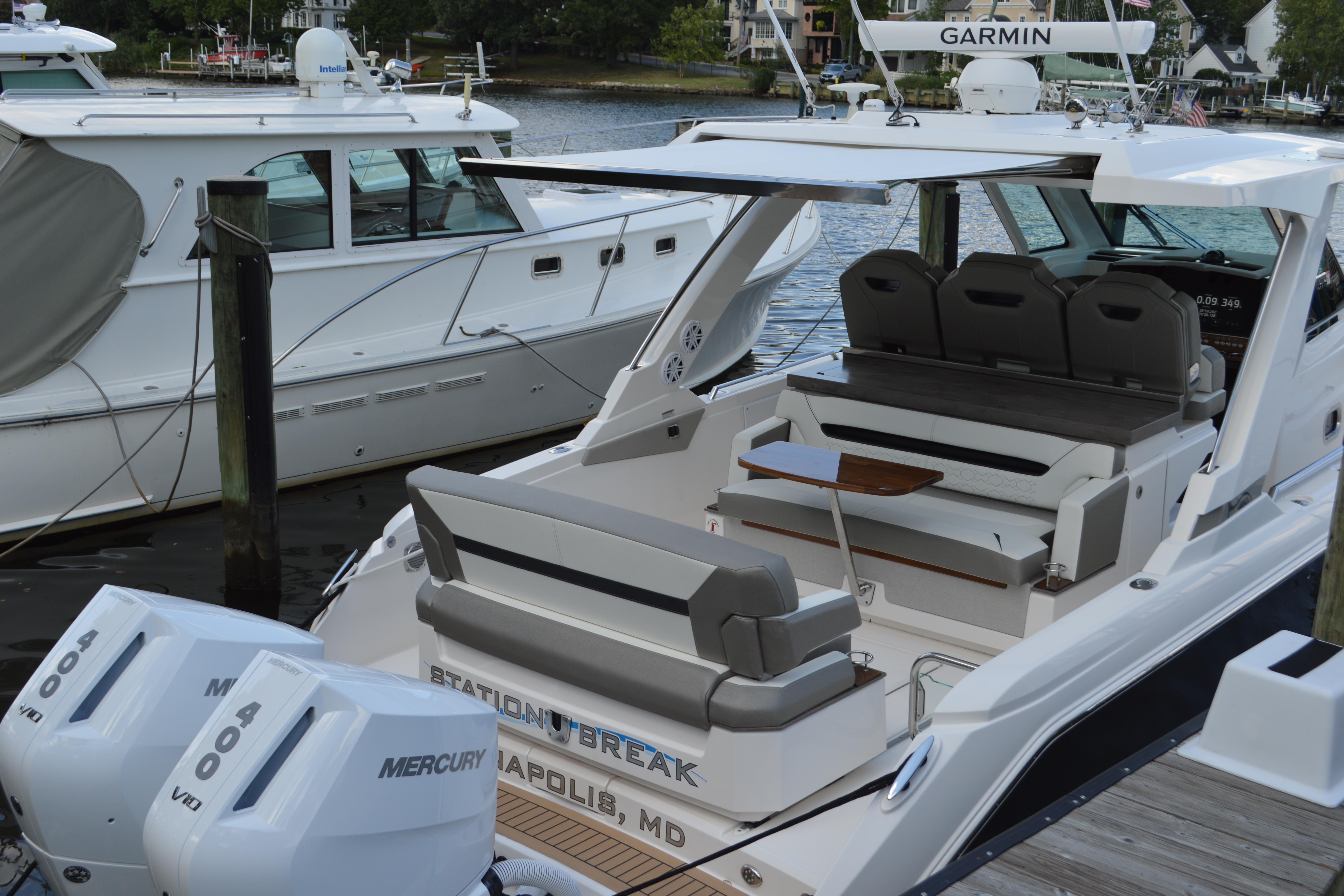 2024 Tiara Yachts 34 LS docked, featuring spacious seating and dual Mercury engines.