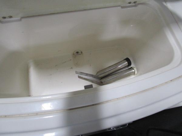 2017 Larson 292 LXI boat compartment with metal parts inside.