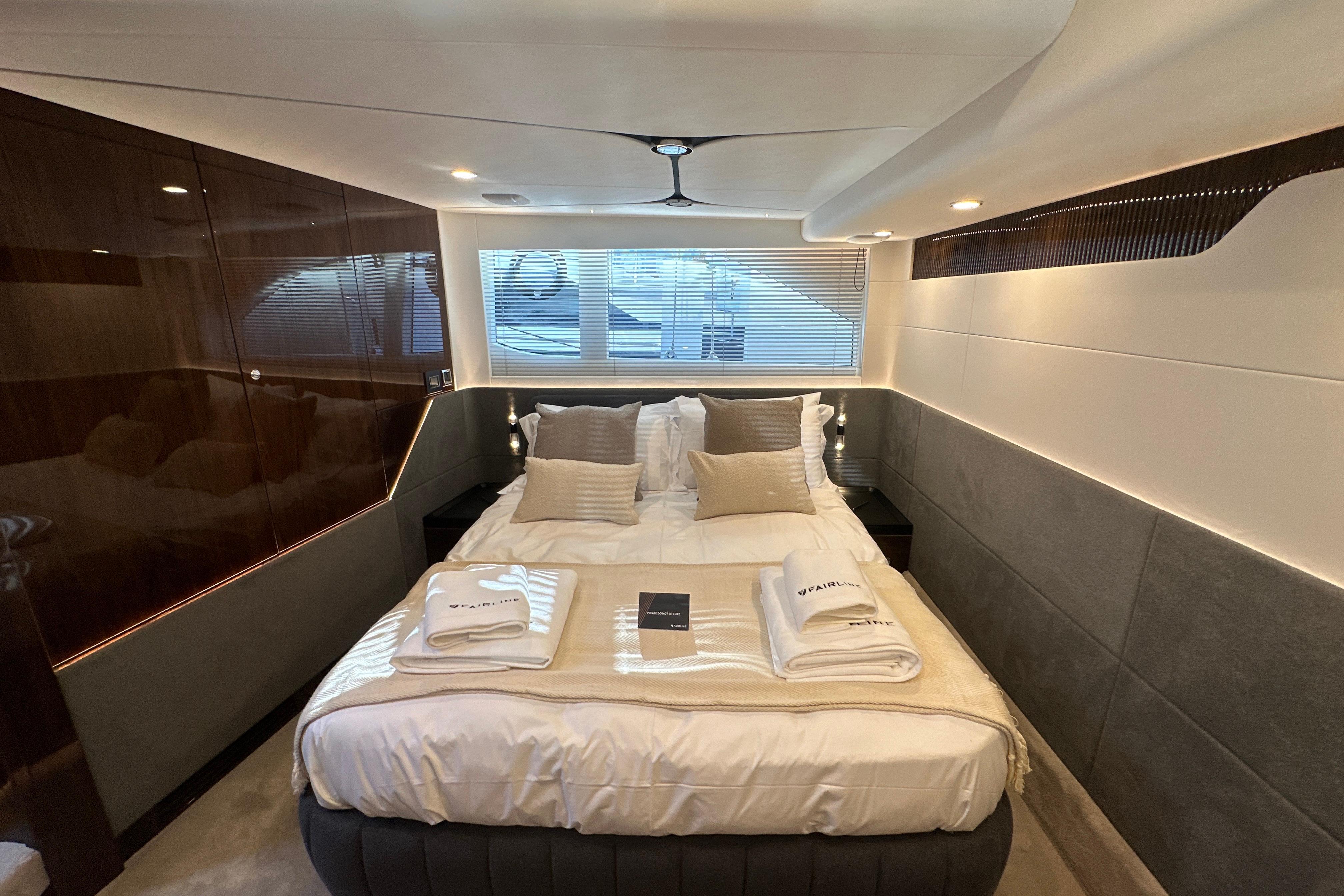 Luxurious bedroom interior of 2026 Fairline Targa 47 GT yacht with elegant bedding.