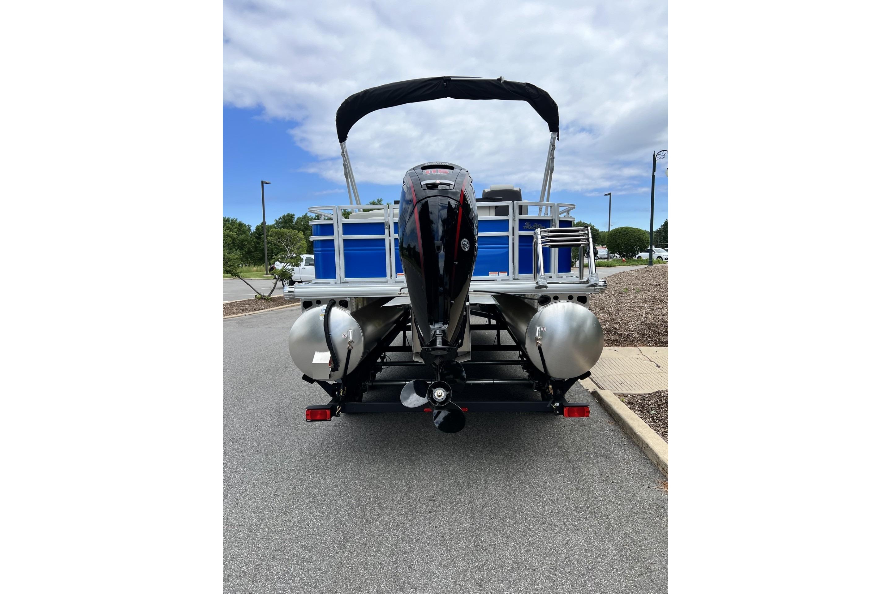 2026 Sun Tracker Fishin' Barge 20 DLX pontoon boat, rear view with outboard motor.
