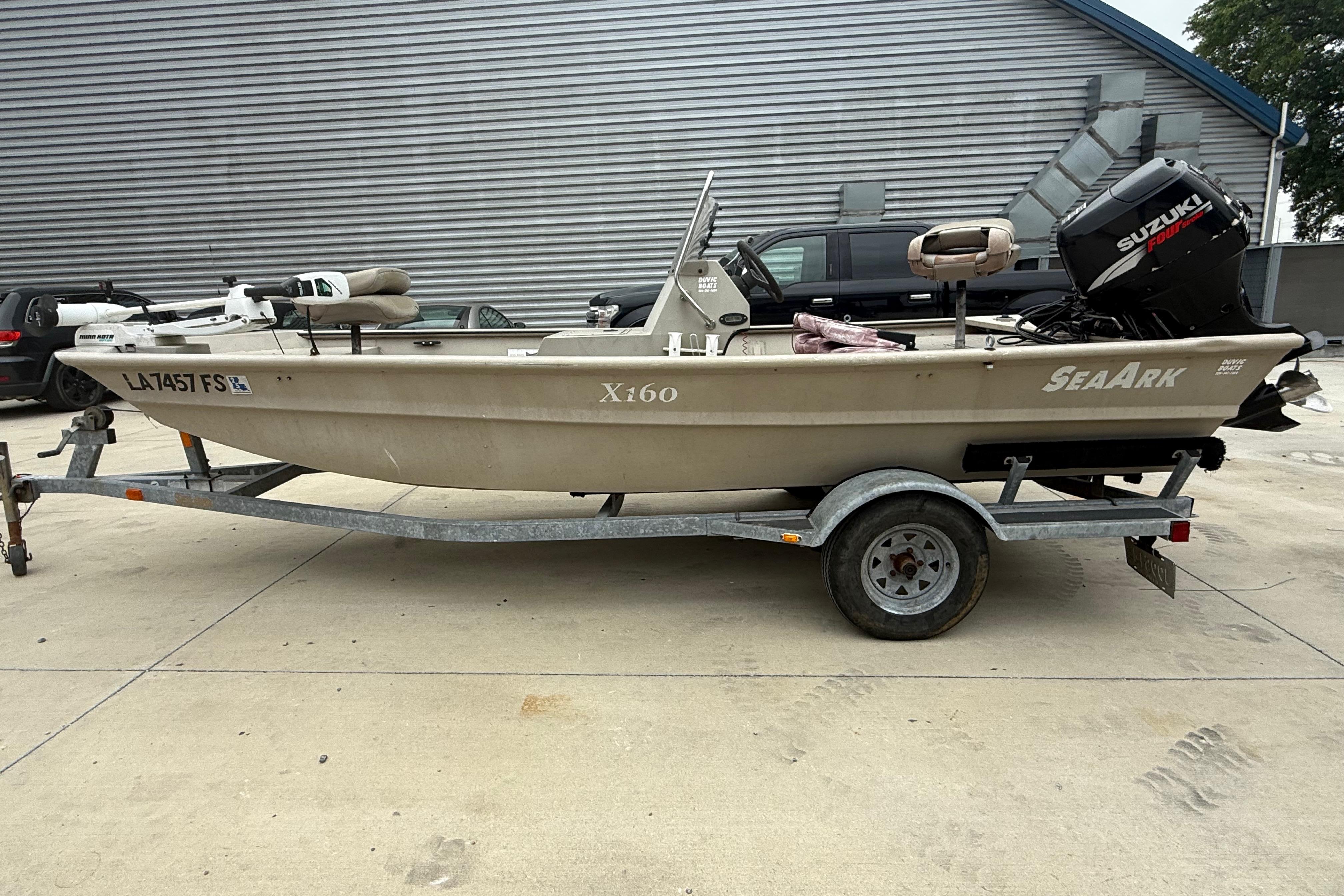 2008 SeaArk 1652 MV boat on trailer with Suzuki outboard motor.