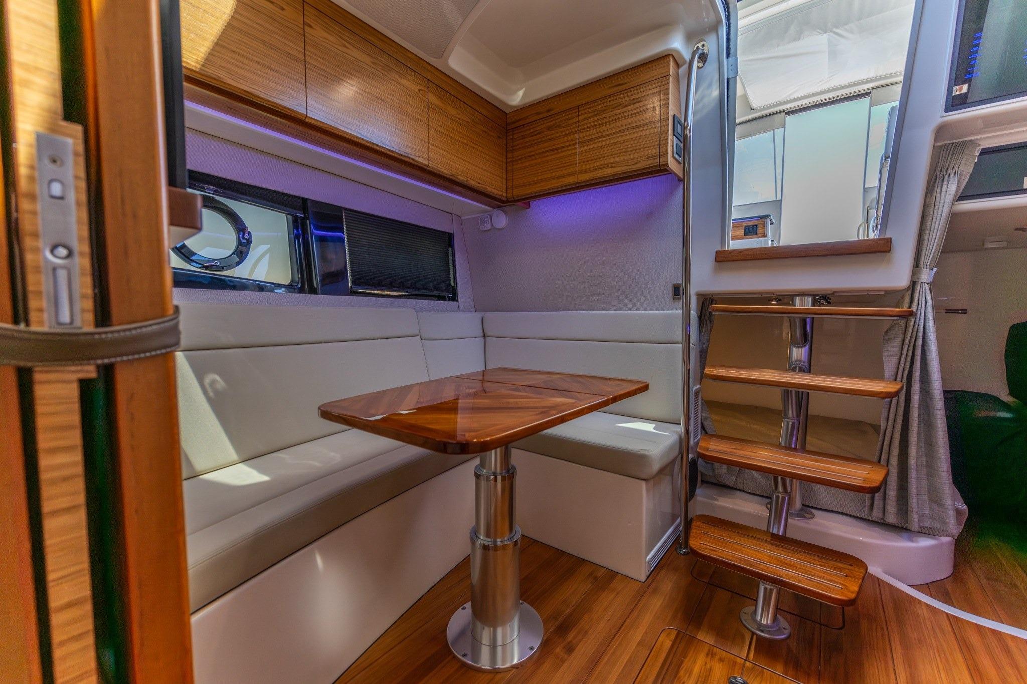 Luxurious interior of 2023 Boston Whaler 405 Conquest with wooden accents and modern seating.