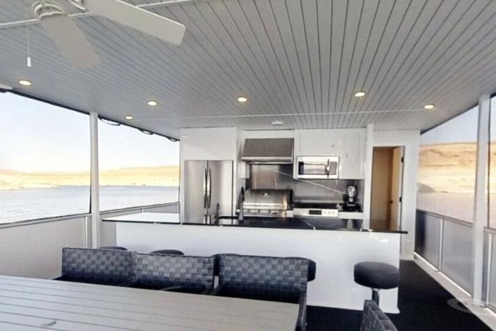 Luxurious houseboat kitchen with modern appliances, spacious seating, and scenic water views. Adonia Galileo Trip 2023.