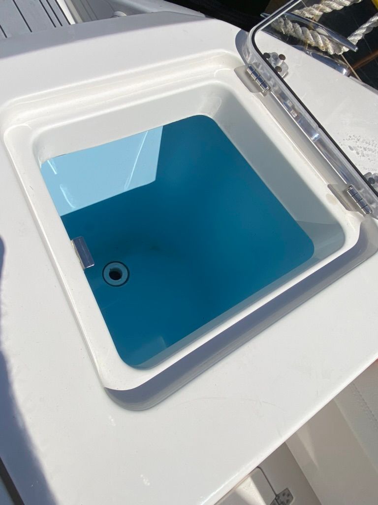 Cobia 330 boat 2023 with open storage compartment.