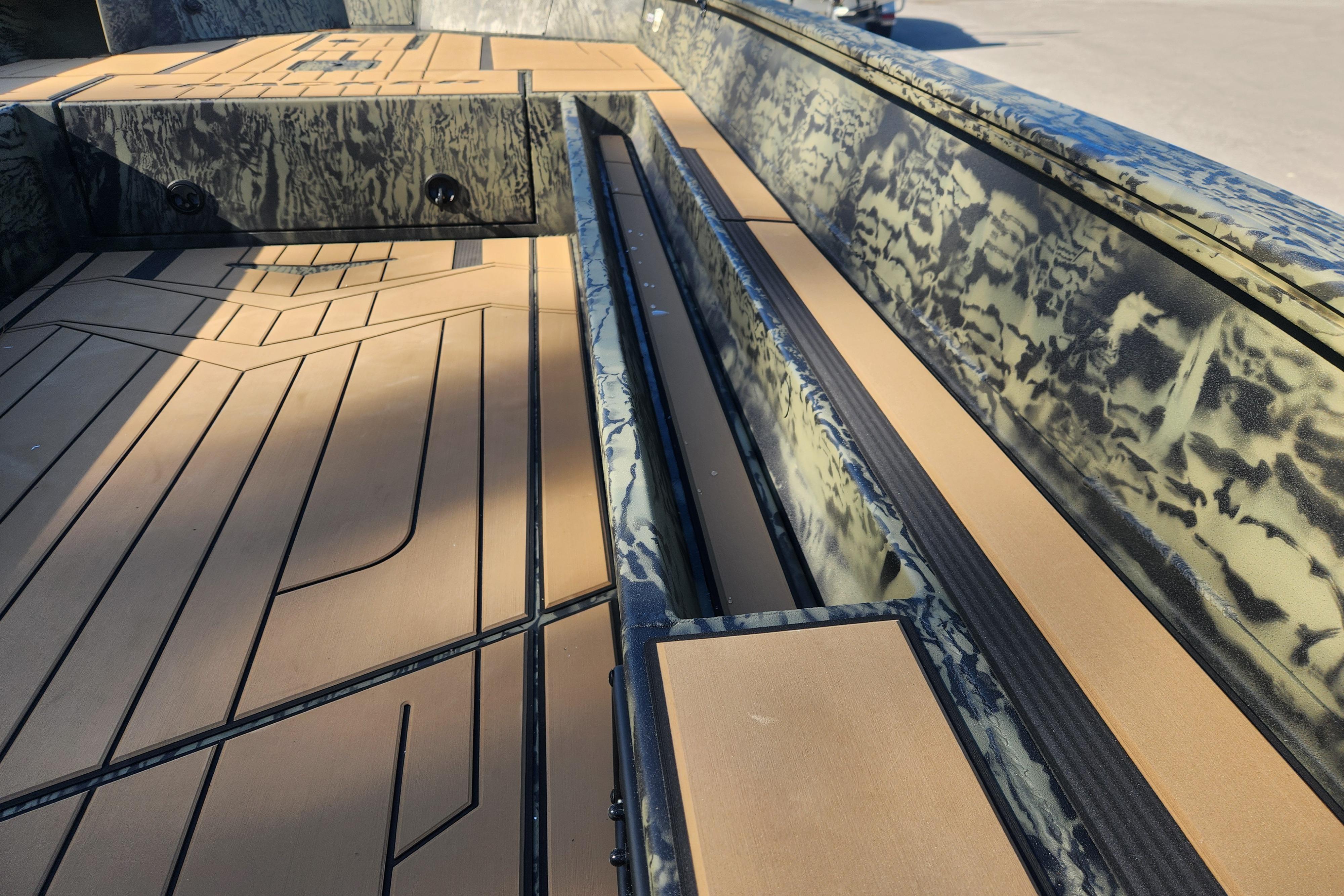 2026 Tracker Grizzly 1756 T Marsh boat interior with camouflage design and tan flooring.