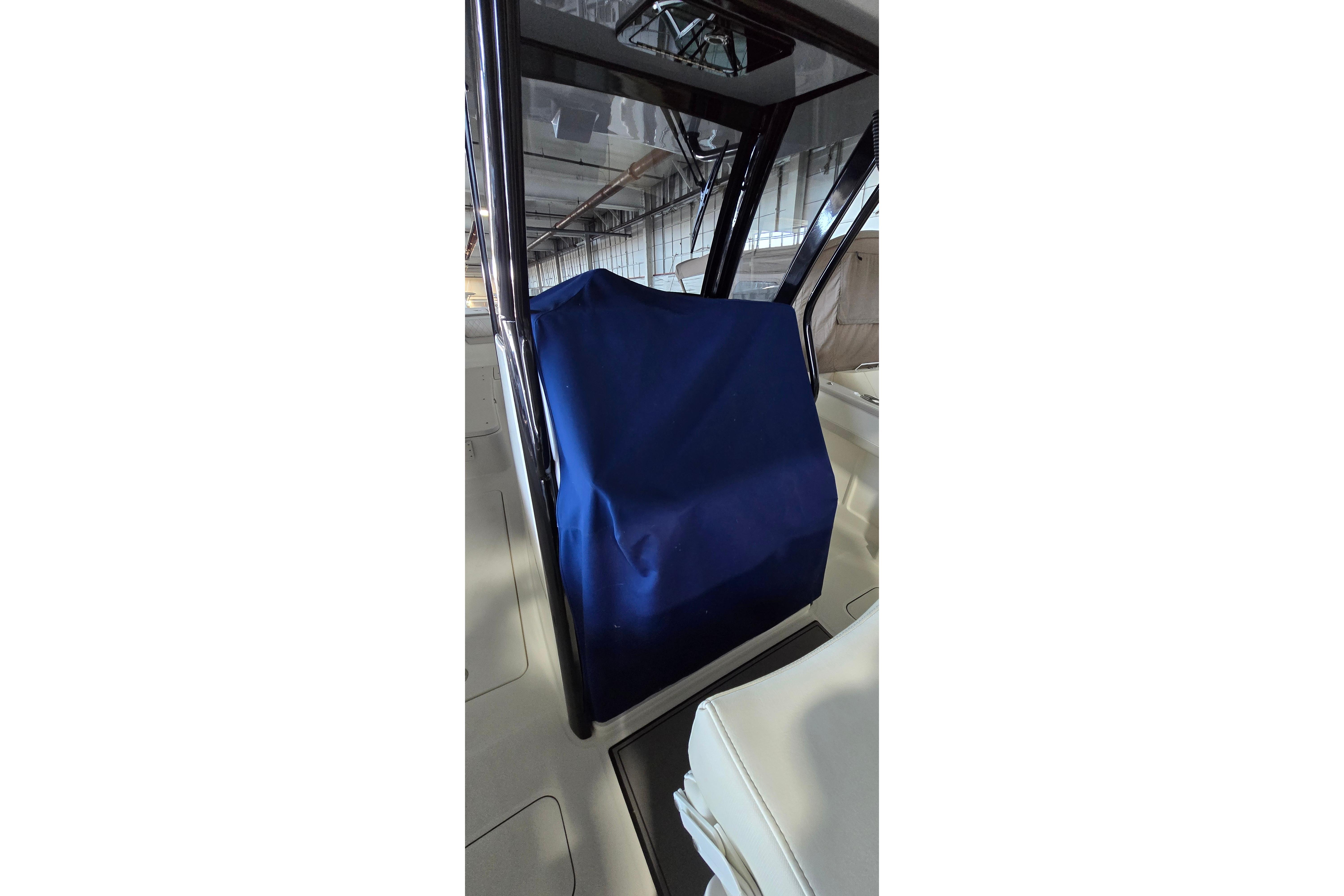2024 WorldCat 280 CC-X boat interior with blue cover, showcasing sleek design.