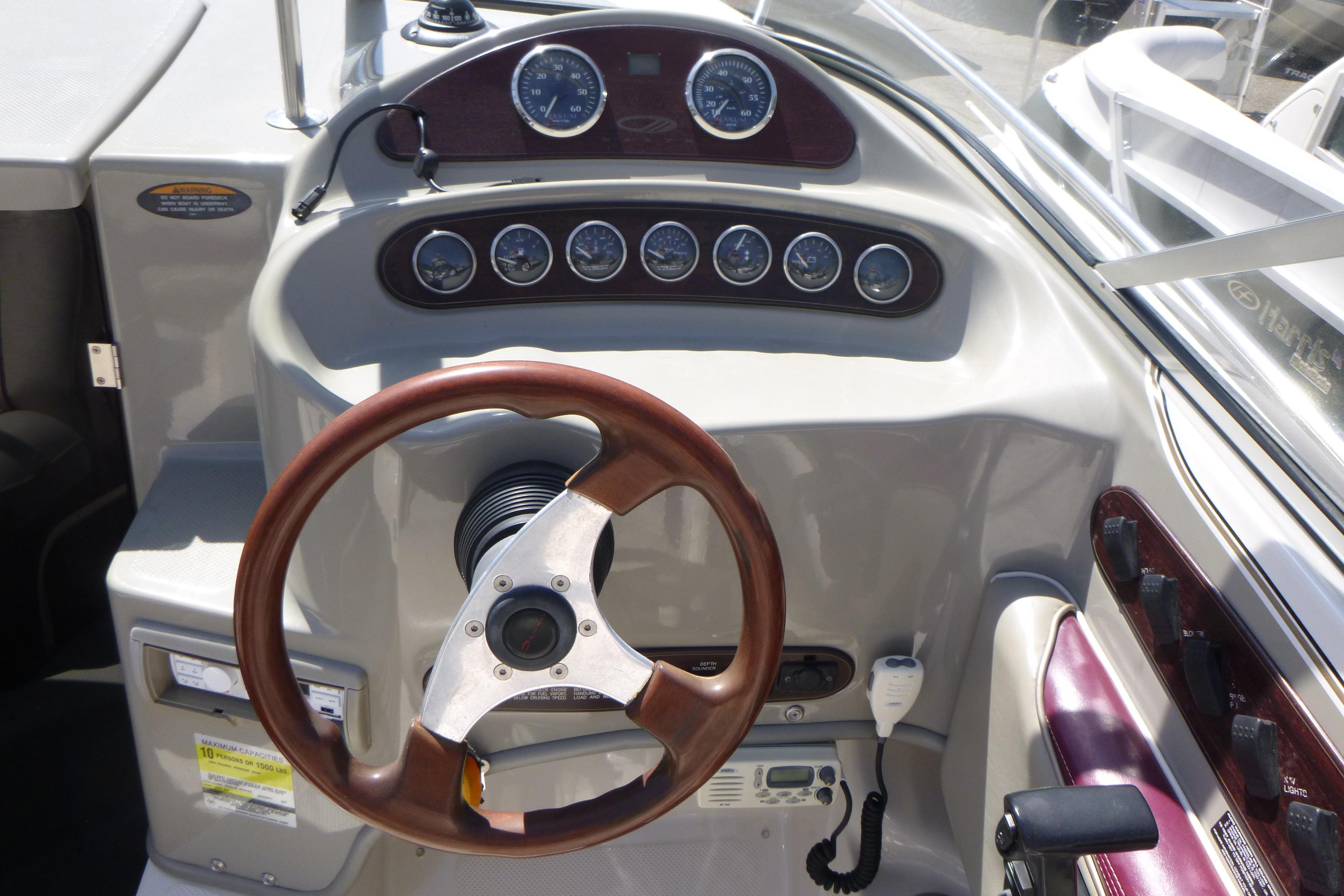 1998 Maxum 2300 SC boat dashboard with gauges and steering wheel.