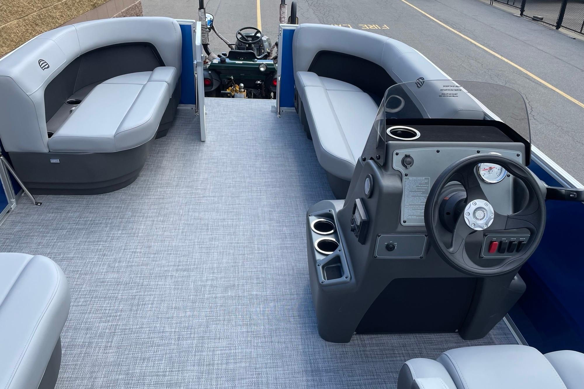 2026 Sun Tracker Party Barge 16 DLX interior with seating and steering console.