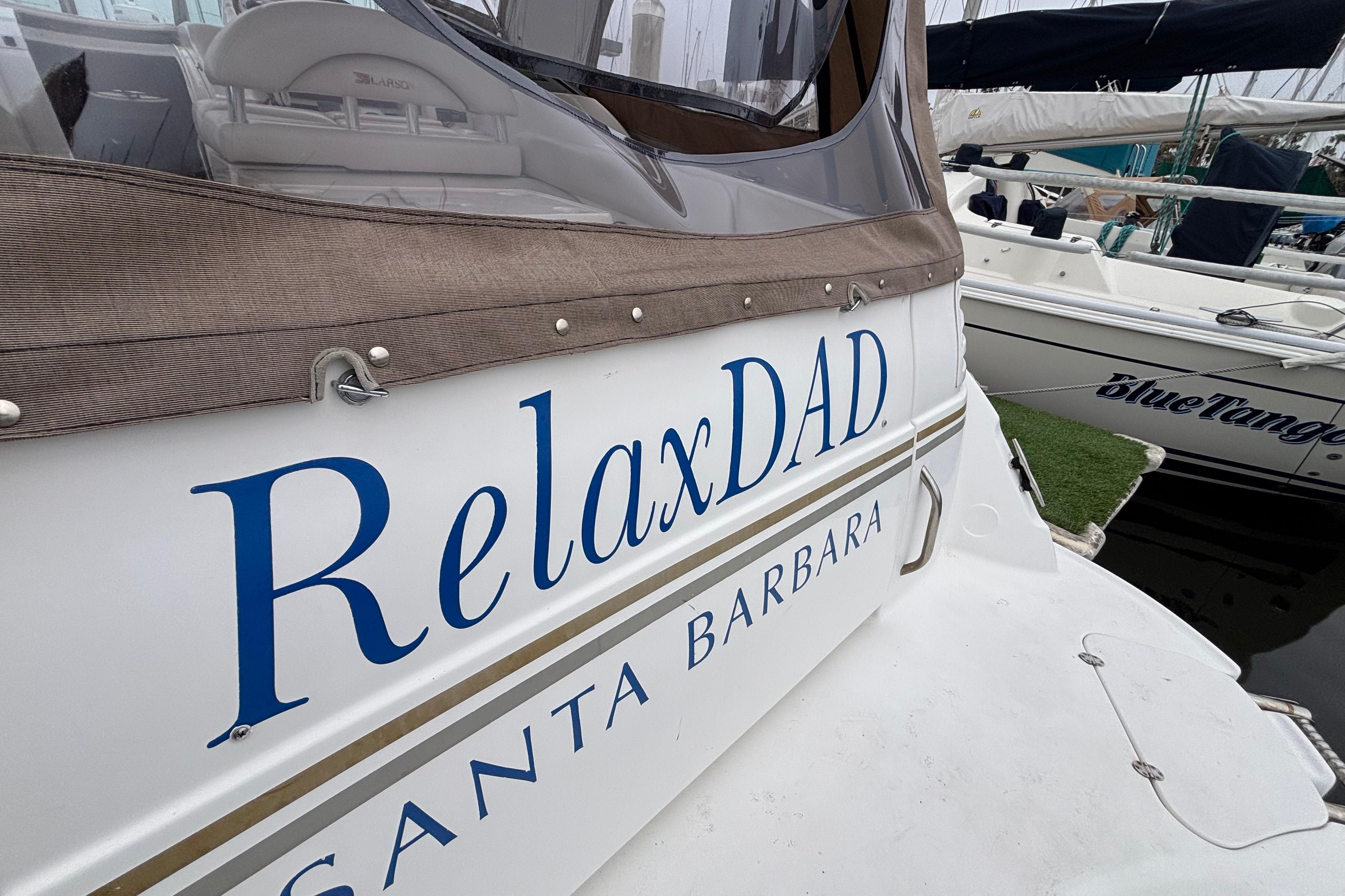 Larson 310 boat named "RelaxDAD" docked in Santa Barbara, 2004 model.
