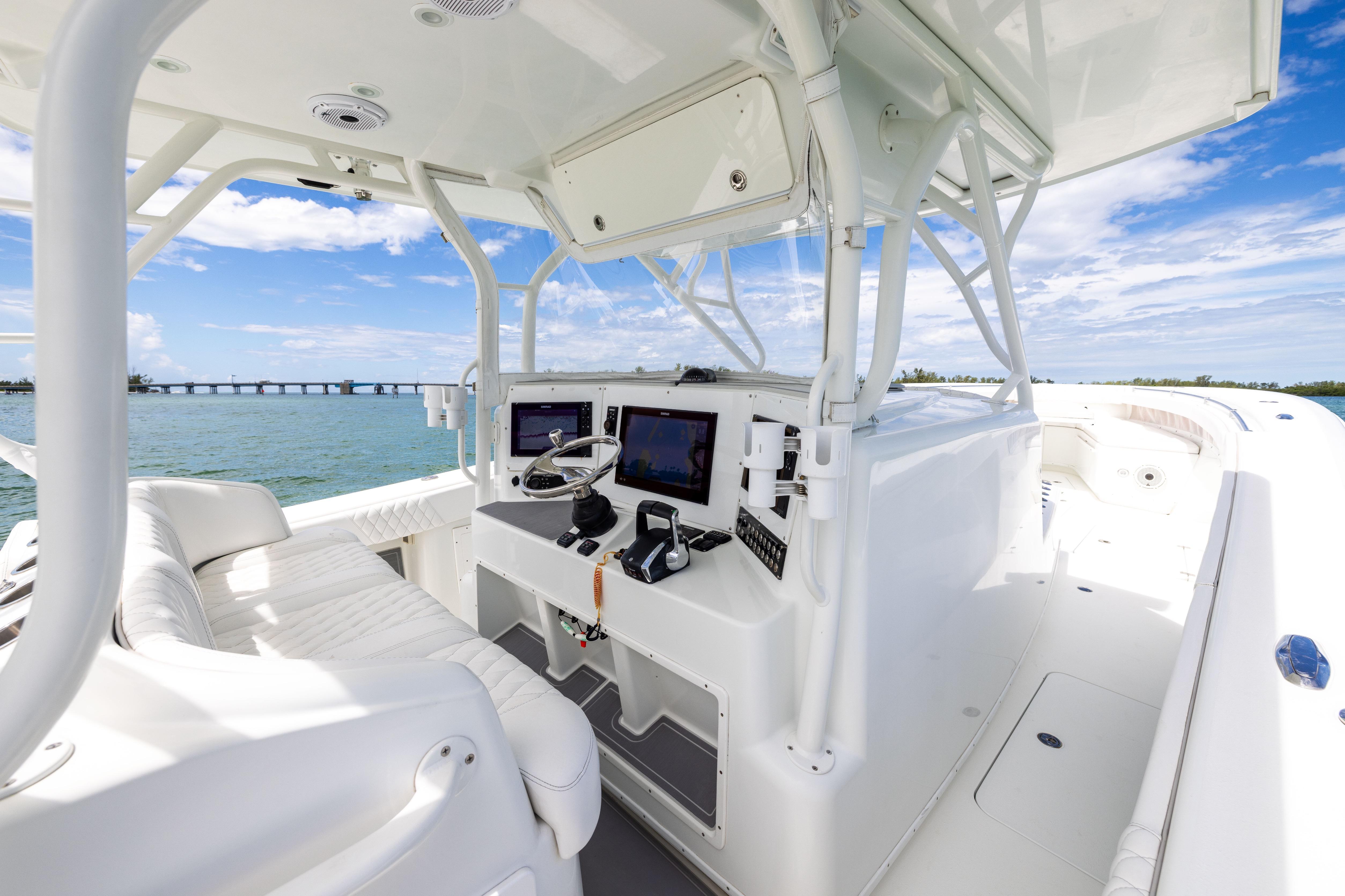 2009 Yellowfin 42 Offshore boat interior with modern navigation equipment and ocean view.