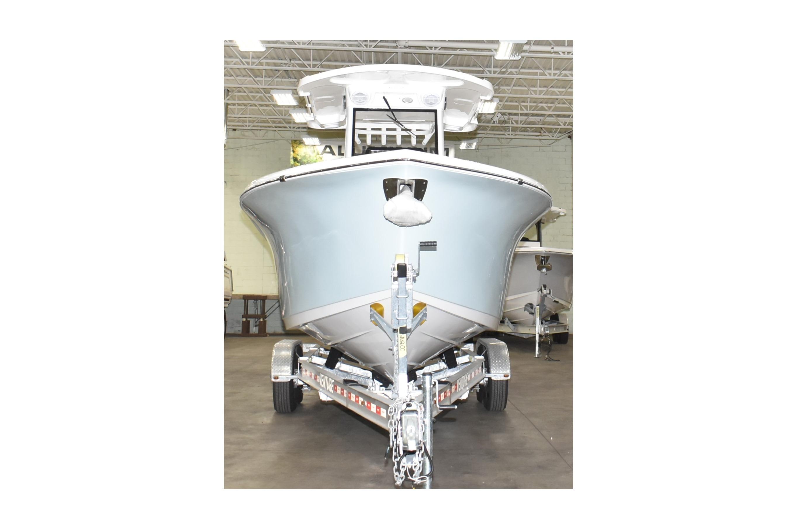 2025 Sea Pro 262 Offshore boat on trailer in indoor showroom.