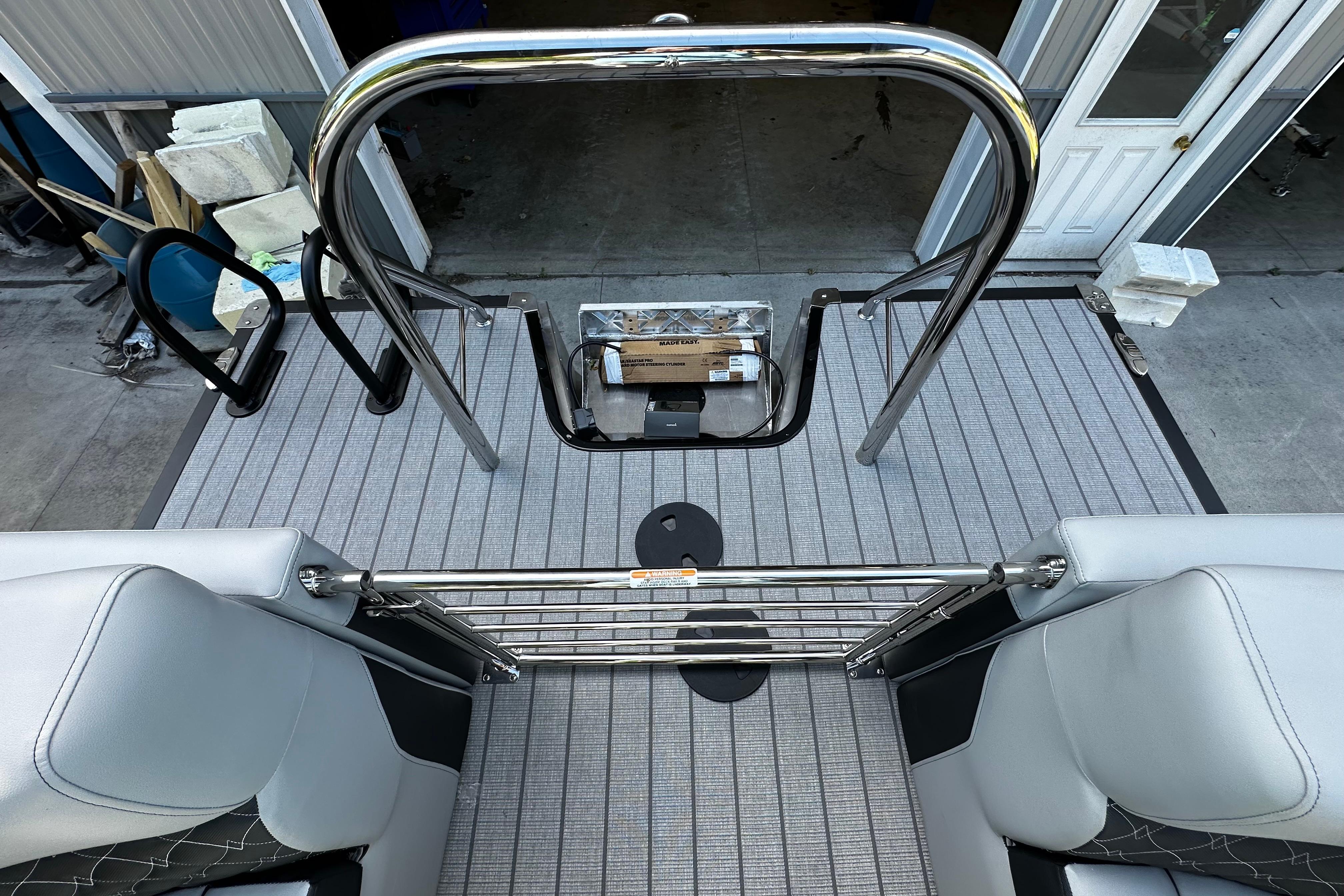 2027 Manitou 25 Encore RF boat deck with sleek seating and stainless steel railings.