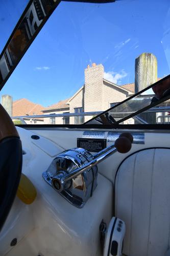 1997 Sunseeker Camargue 47 yacht cockpit with control lever, blue sky background.