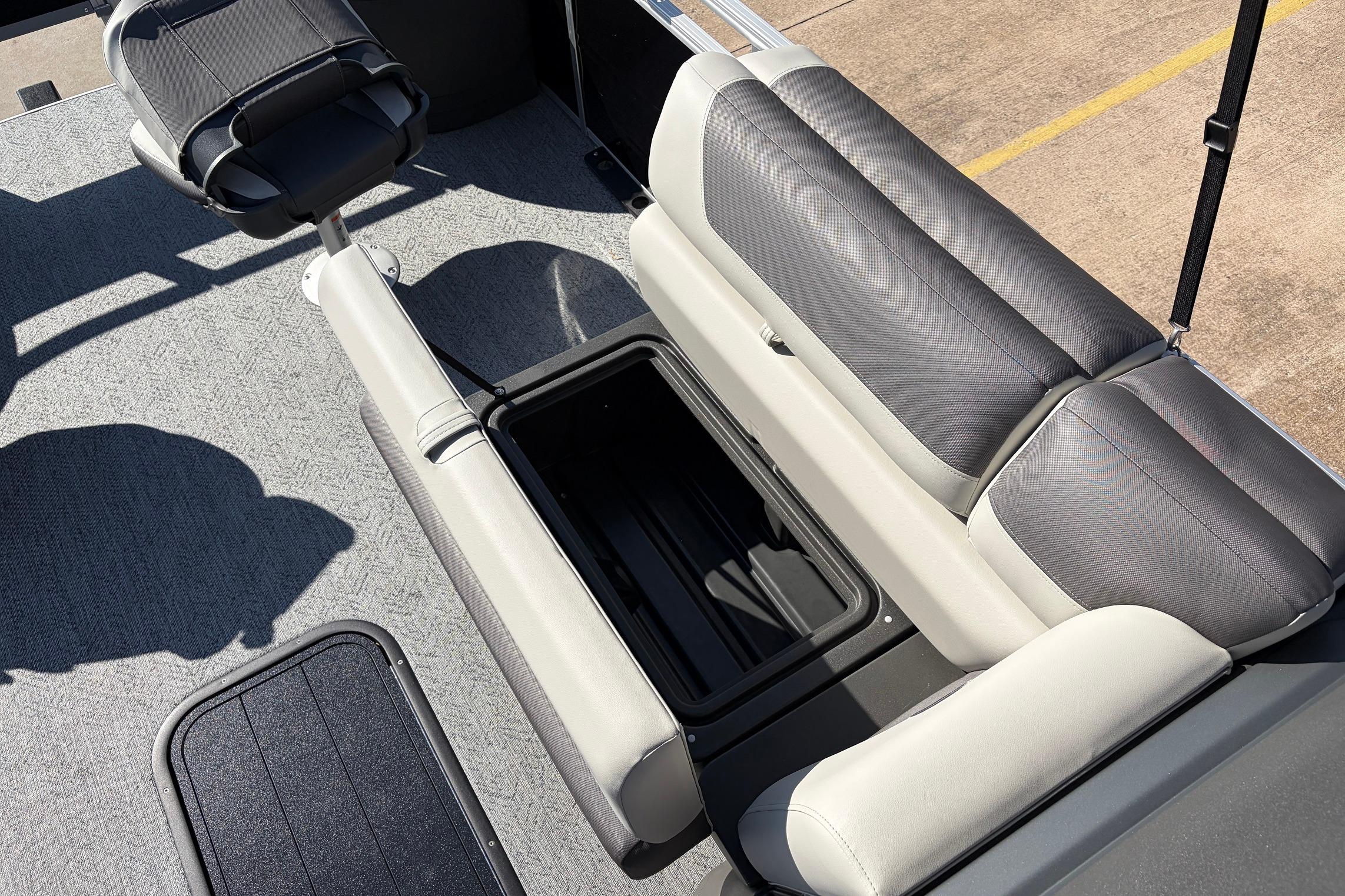2026 Sun Tracker Fishin' Barge 22 XP3 interior with open storage compartment and seating.