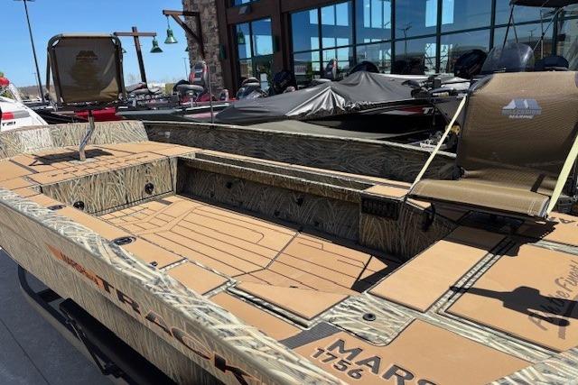 2026 Tracker Grizzly 1756 T Marsh boat with camouflage design, displayed outdoors.