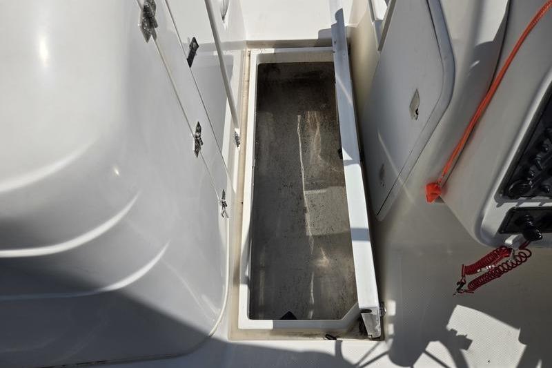 Open storage compartment on 2004 Aquasport 215 Osprey Sport boat deck.