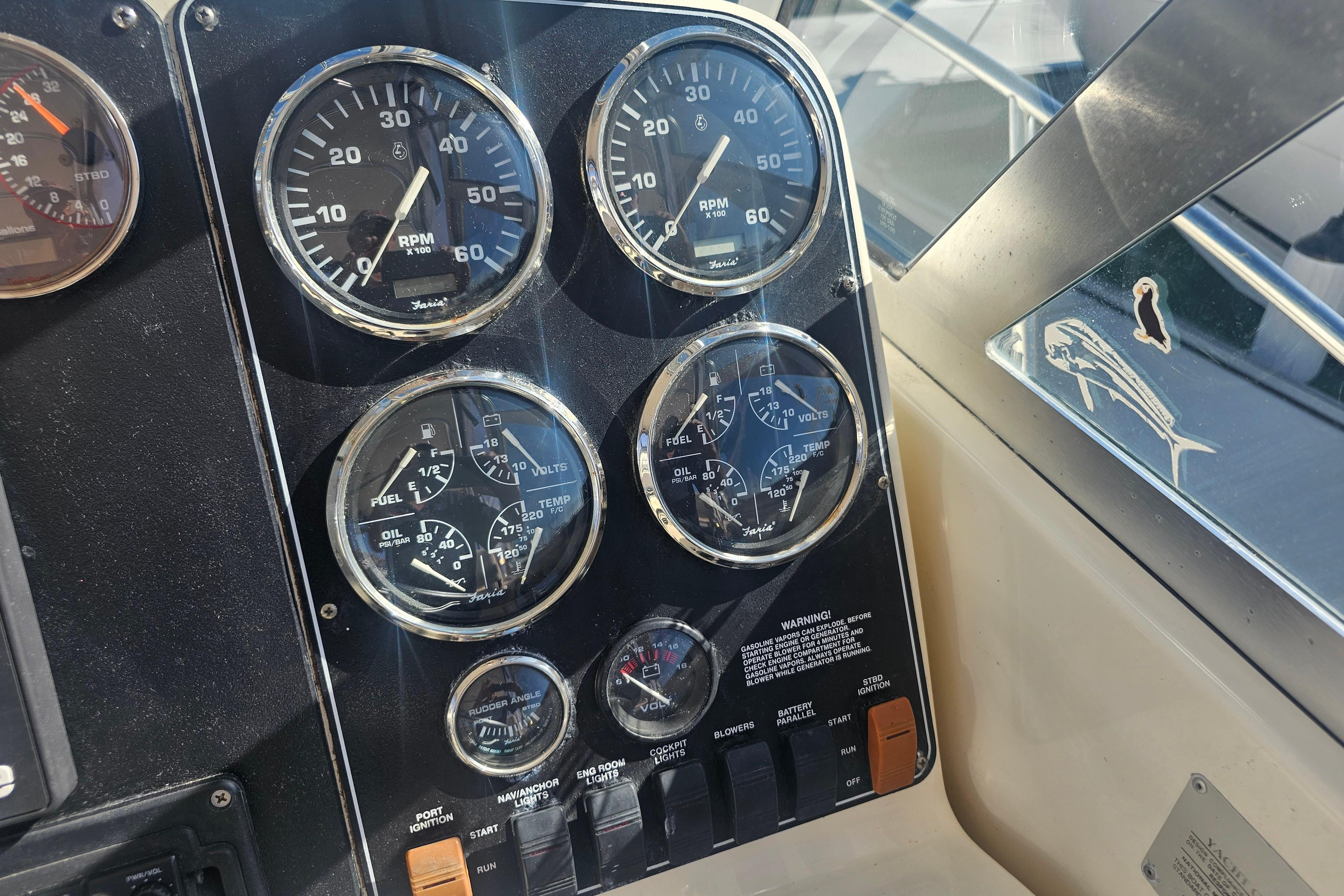 Dashboard of a 2001 Pursuit 3000 Express boat with various gauges and controls.