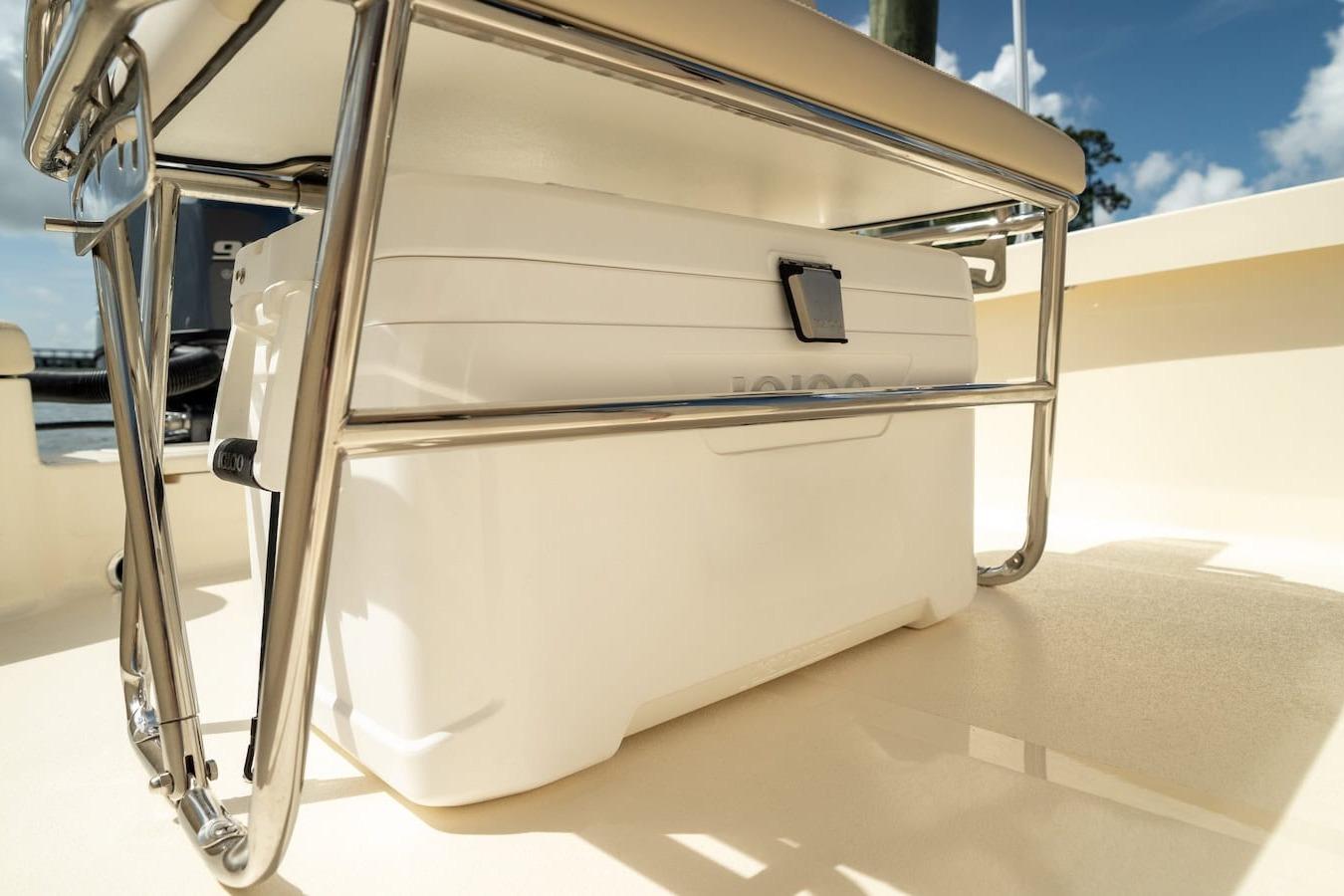 2026 Scout 188 Sportfish boat with cooler under seat, sunny day.