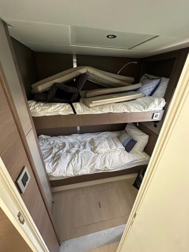 Bunk beds in a 2021 Bali 4.8 yacht cabin with modern design and cozy bedding.