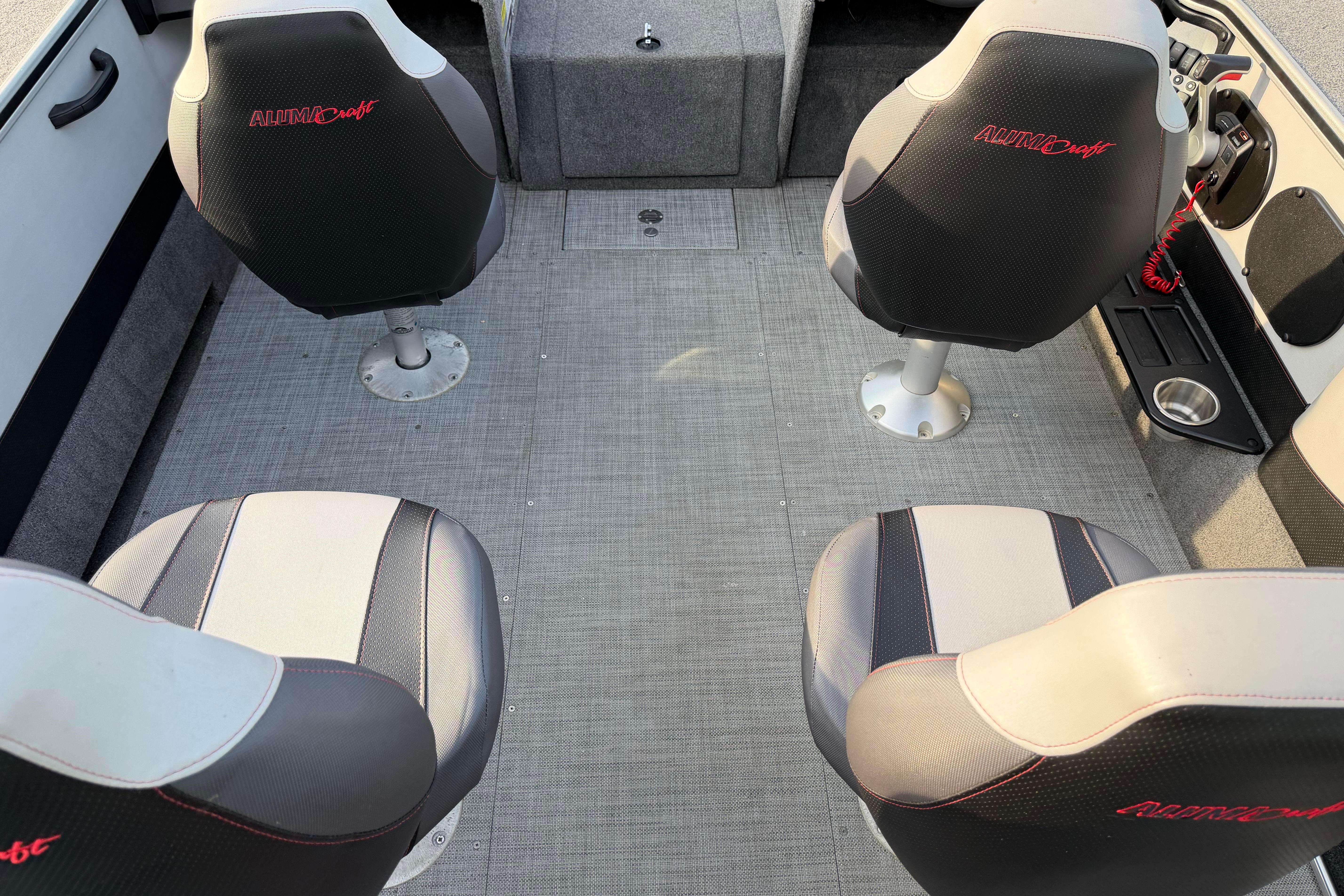 2019 Alumacraft Trophy 205 boat interior with four cushioned seats and carpeted flooring.