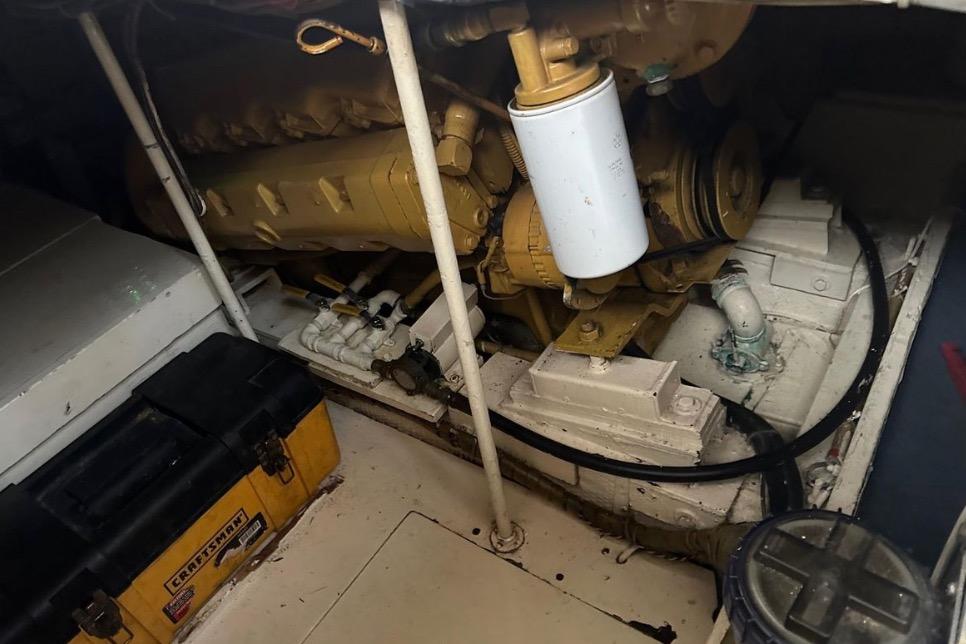 Engine room of 1985 Egg Harbor 33 Sedan with visible machinery and tools.