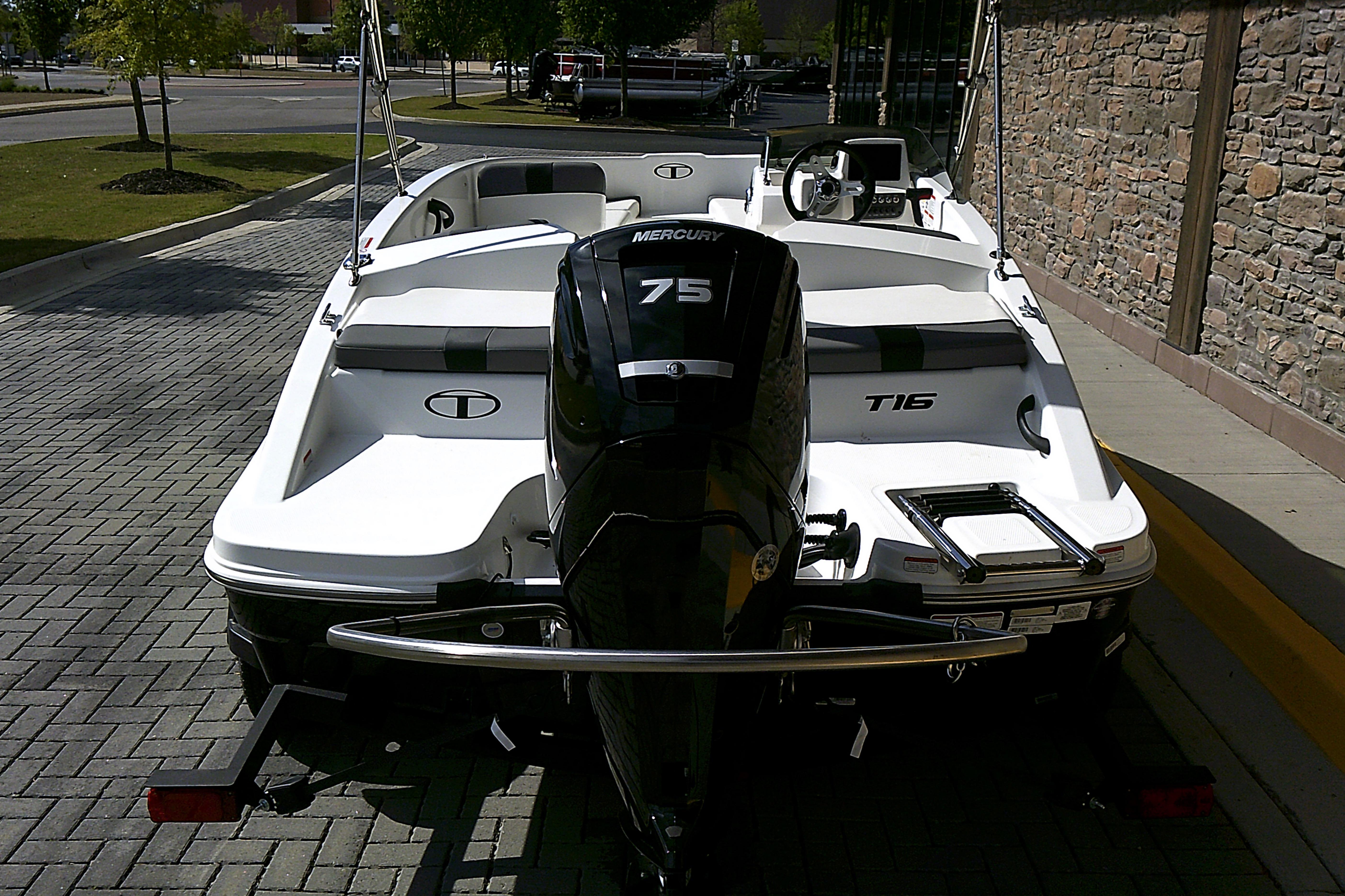 2025 Tahoe T16 boat with Mercury 75 engine, parked on a paved area.