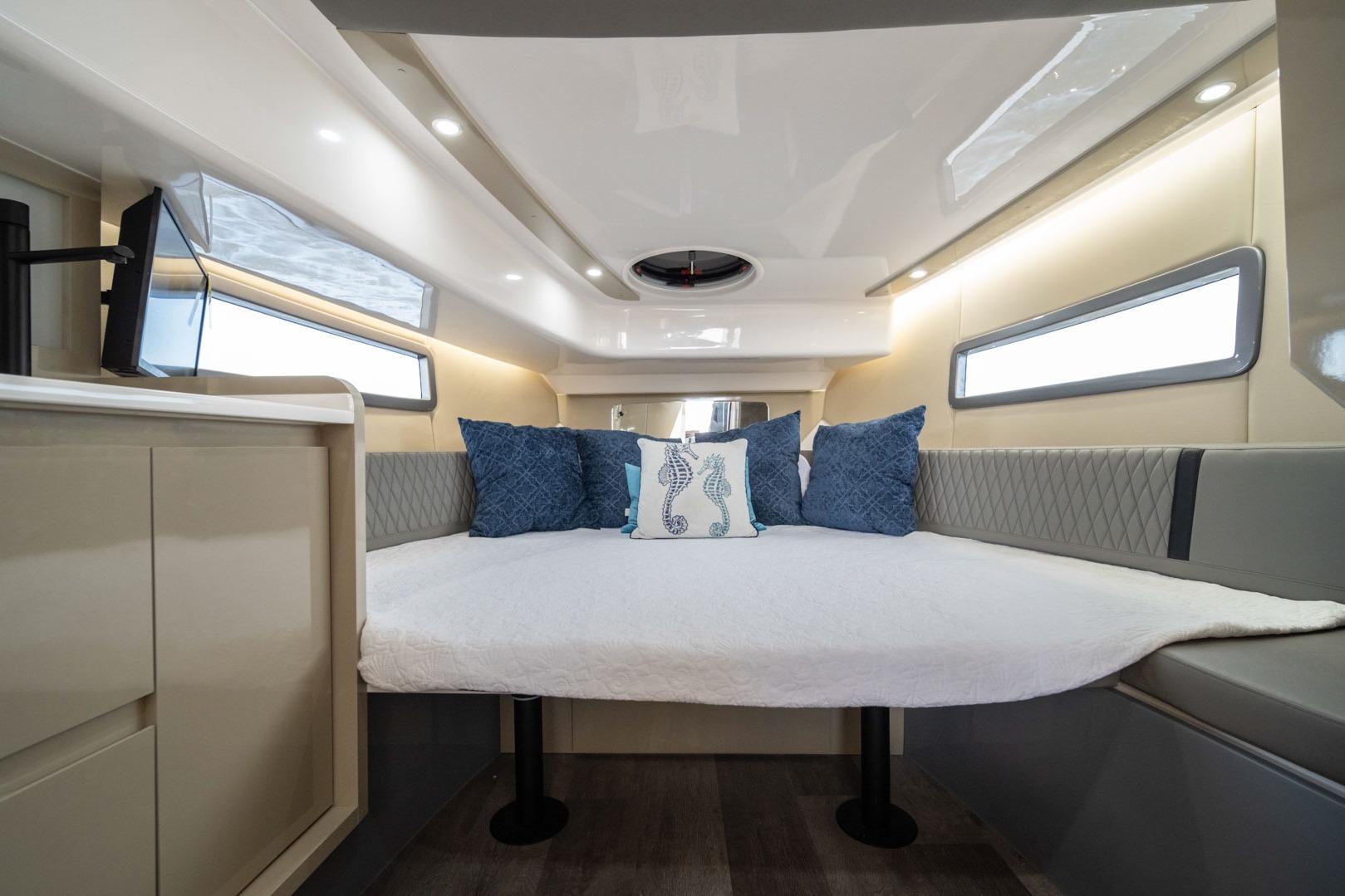 Luxurious interior of 2026 Hanover 387 boat with cozy bed and elegant decor.