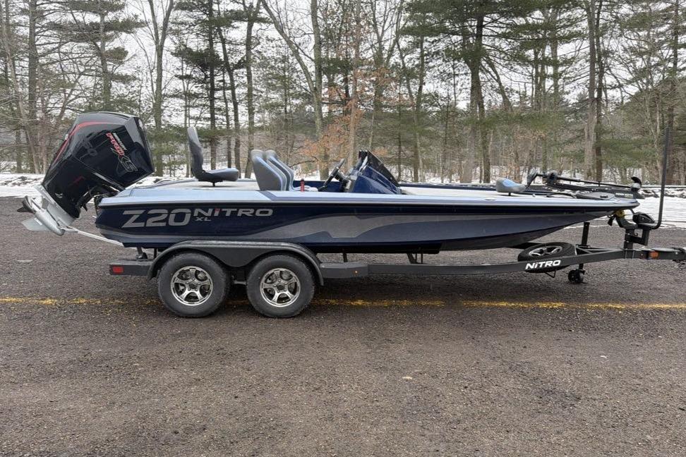 2026 Nitro Z20 XL boat on trailer in wooded area.