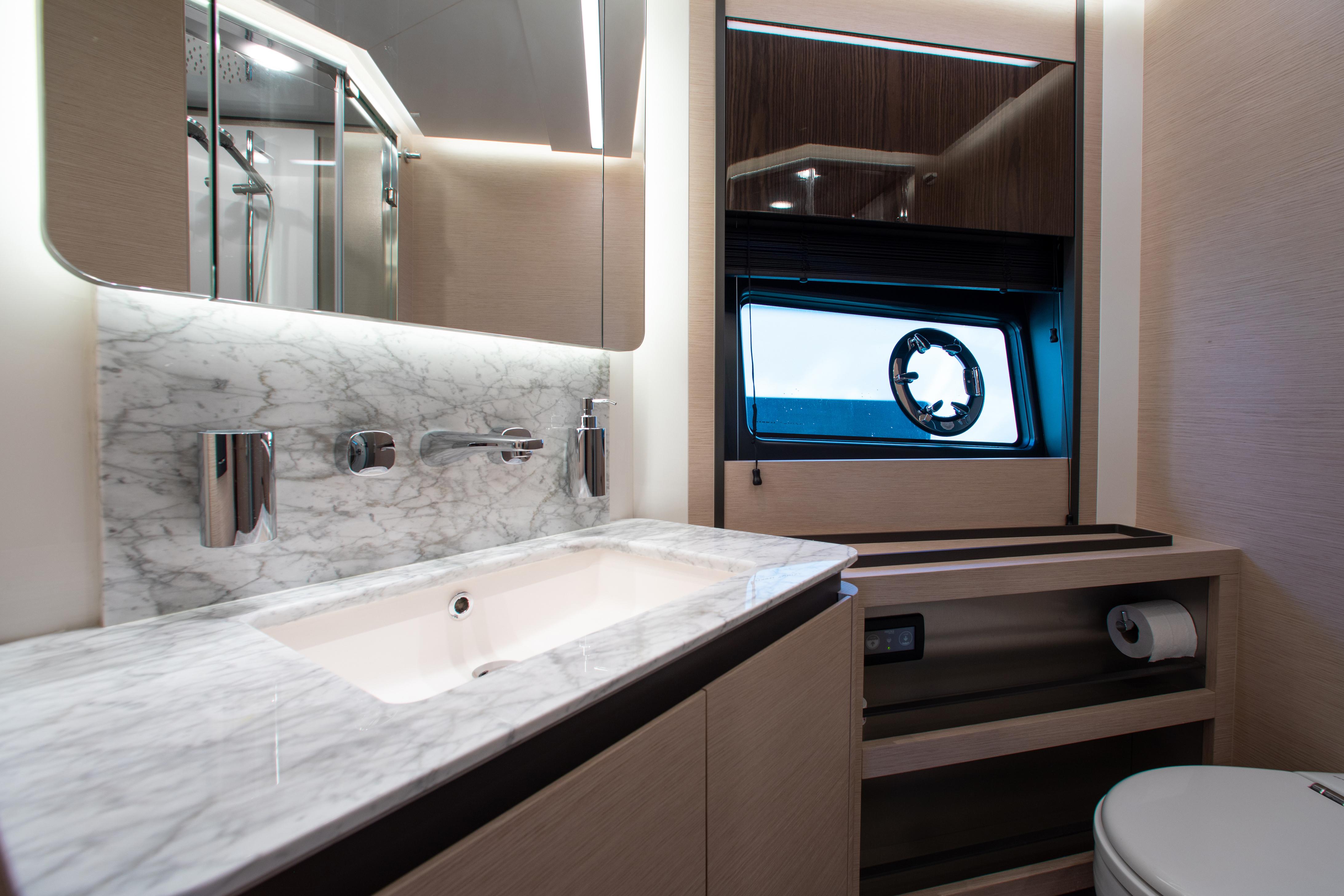 Luxurious bathroom in 2022 Azimut S8 yacht with marble countertop and modern fixtures.