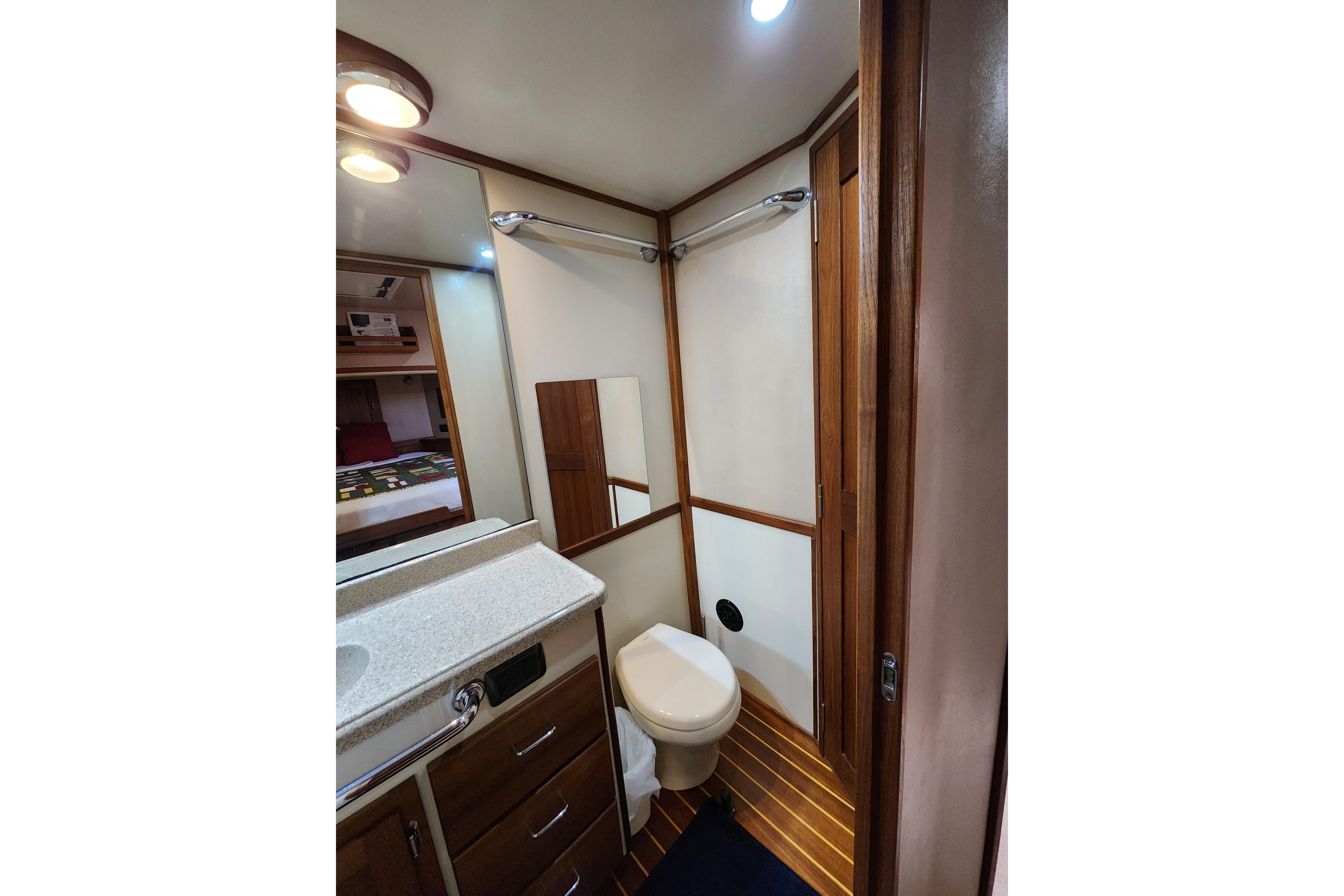 Bathroom interior of 2006 American Tug AT with wood accents and modern fixtures.
