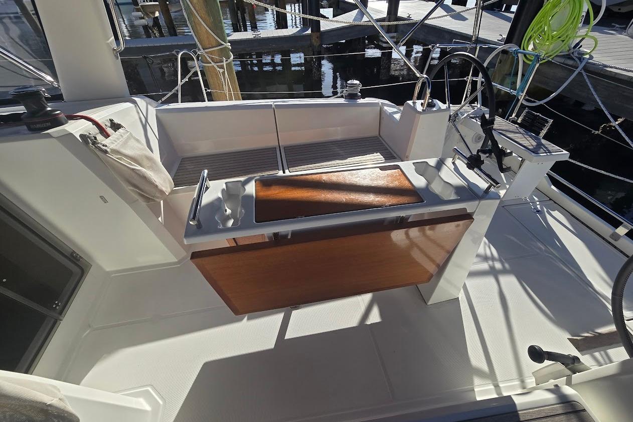 Cockpit of 2023 Beneteau Oceanis 38.1 sailboat with wooden accents and modern design.